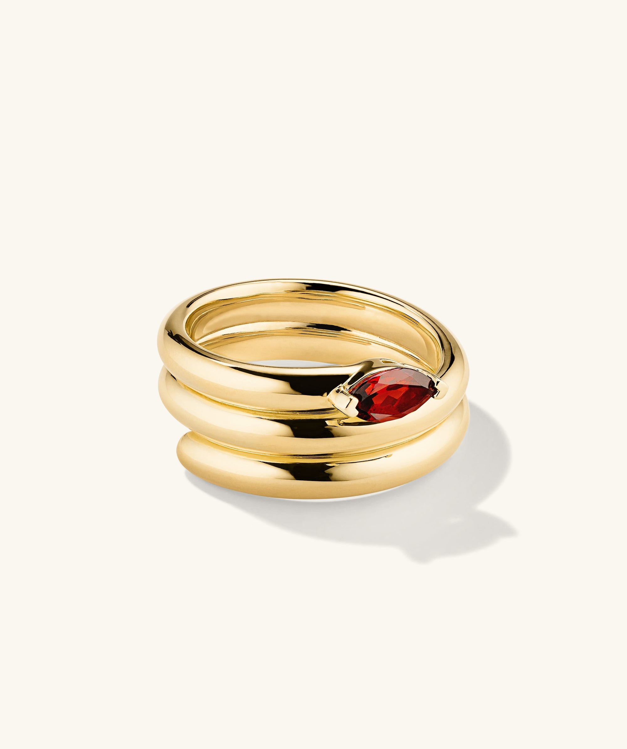 Boa Gemstone Coil Ring: Handcrafted 18k gold vermeil ring featuring a prominent red gemstone, designed to make a bold statement.