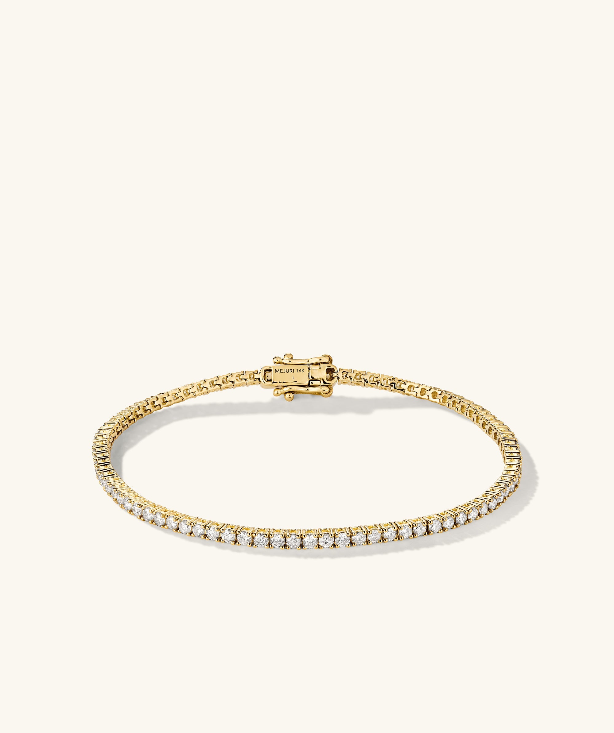 Diamond Tennis Bracelet 1.8mm: A close-up of a gold bracelet adorned with diamonds, featuring a secure clasp mechanism and handcrafted in 14k solid gold.