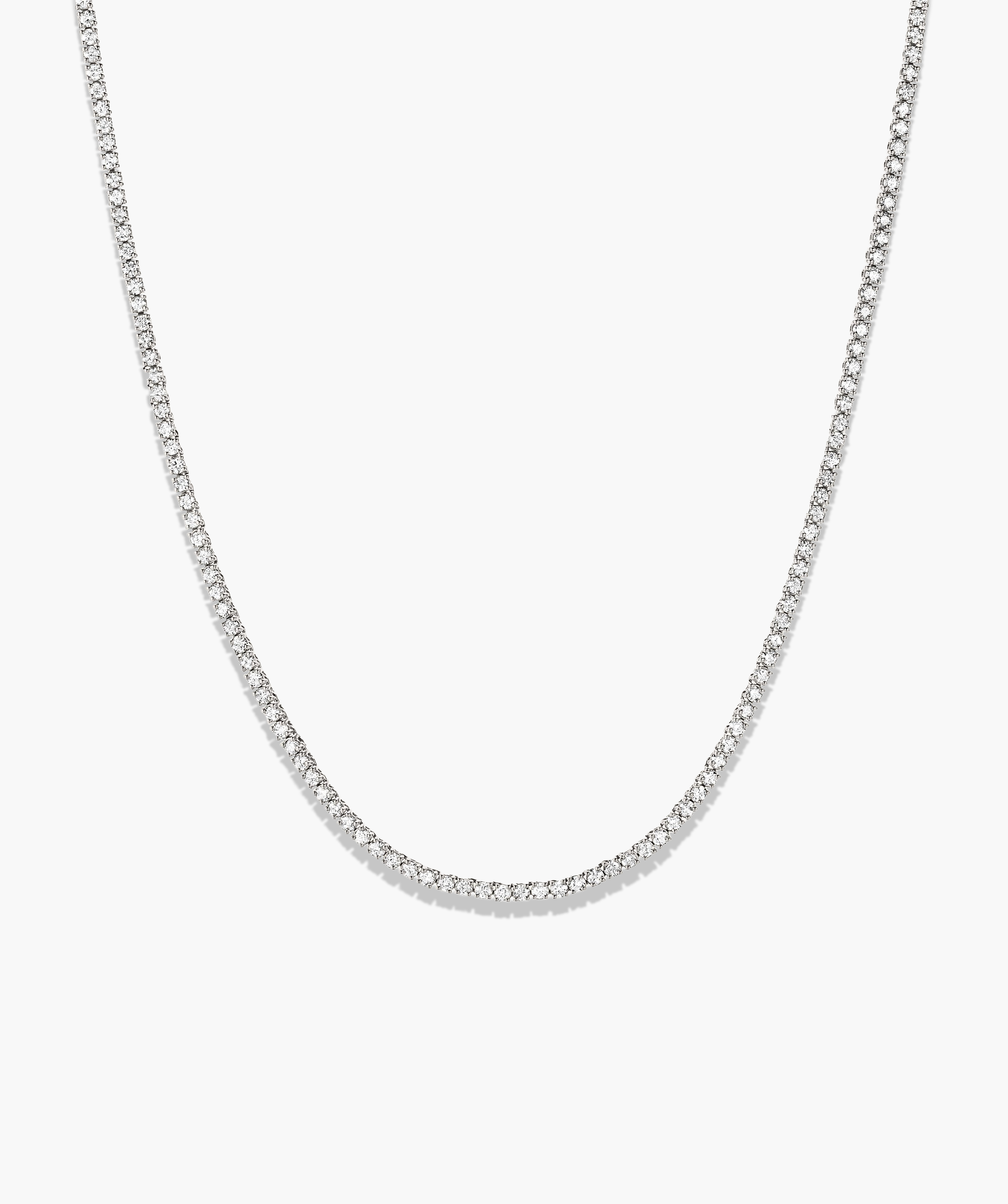 Diamond Tennis Necklace 1.8mm: A silver chain featuring a series of small, sparkling diamonds, handcrafted in 14k solid gold on a white background.