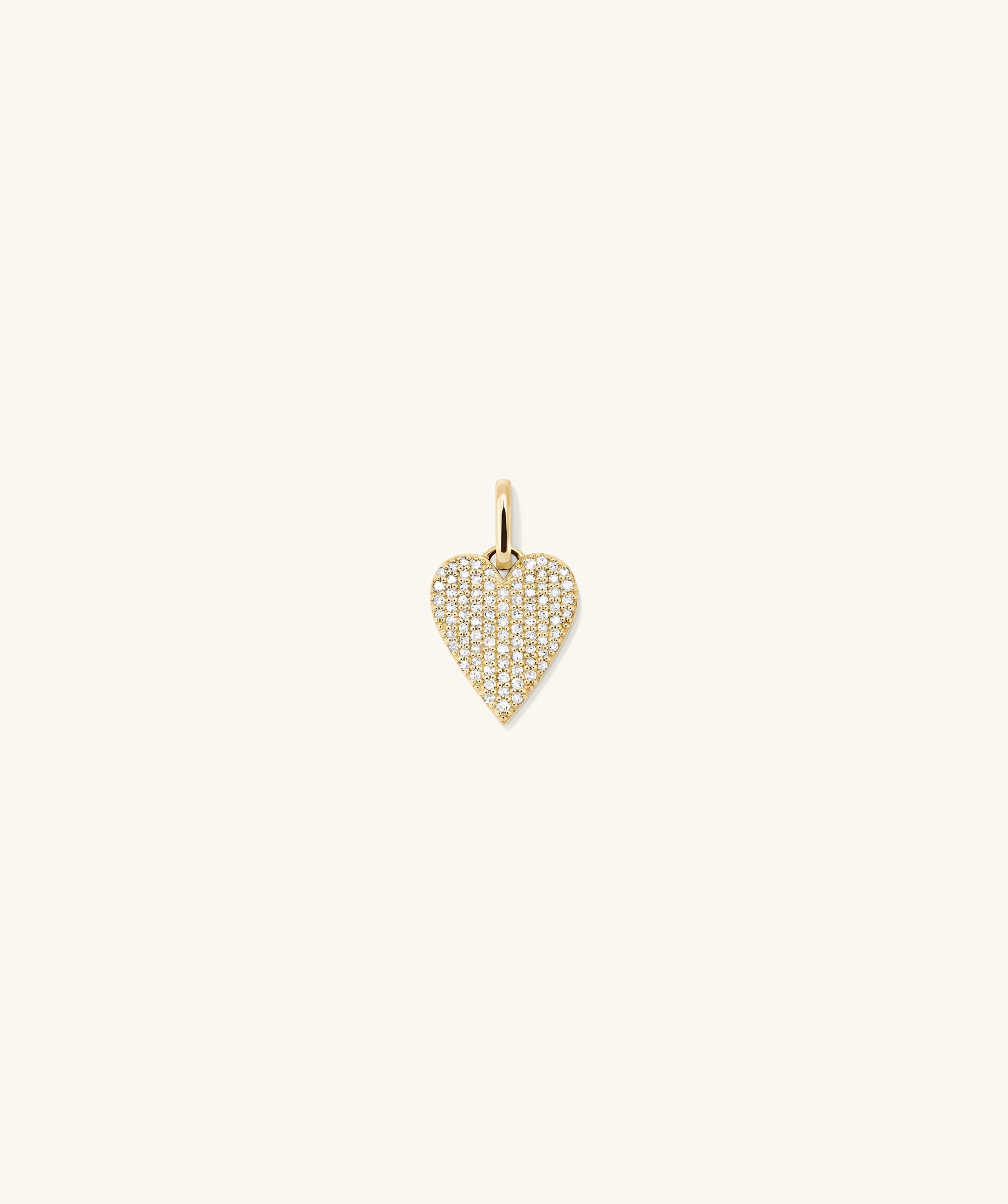 PavÃ© Diamond Heart Pendant: A close-up of a gold heart-shaped pendant adorned with diamonds, showcasing its elegant design and timeless appeal.