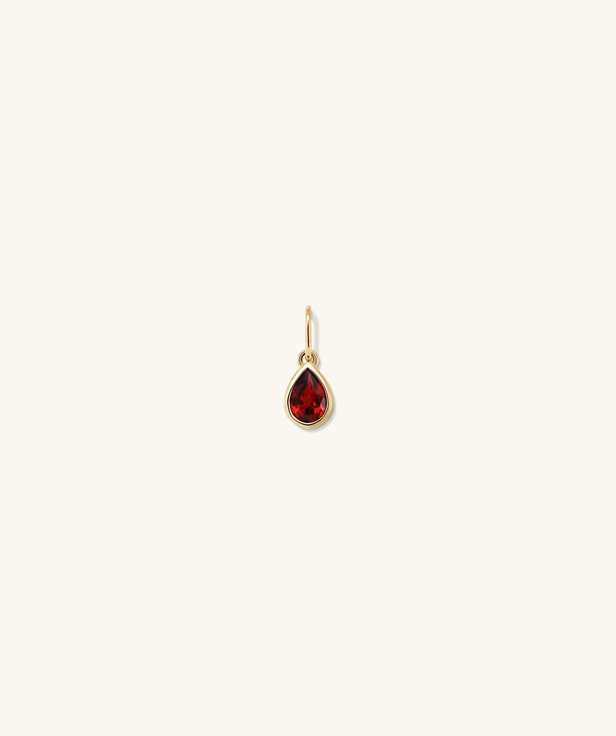 Close-up of the Small Pear Pendant, featuring a red gem at its center, designed to enhance everyday elegance with its unique shape and shine.
