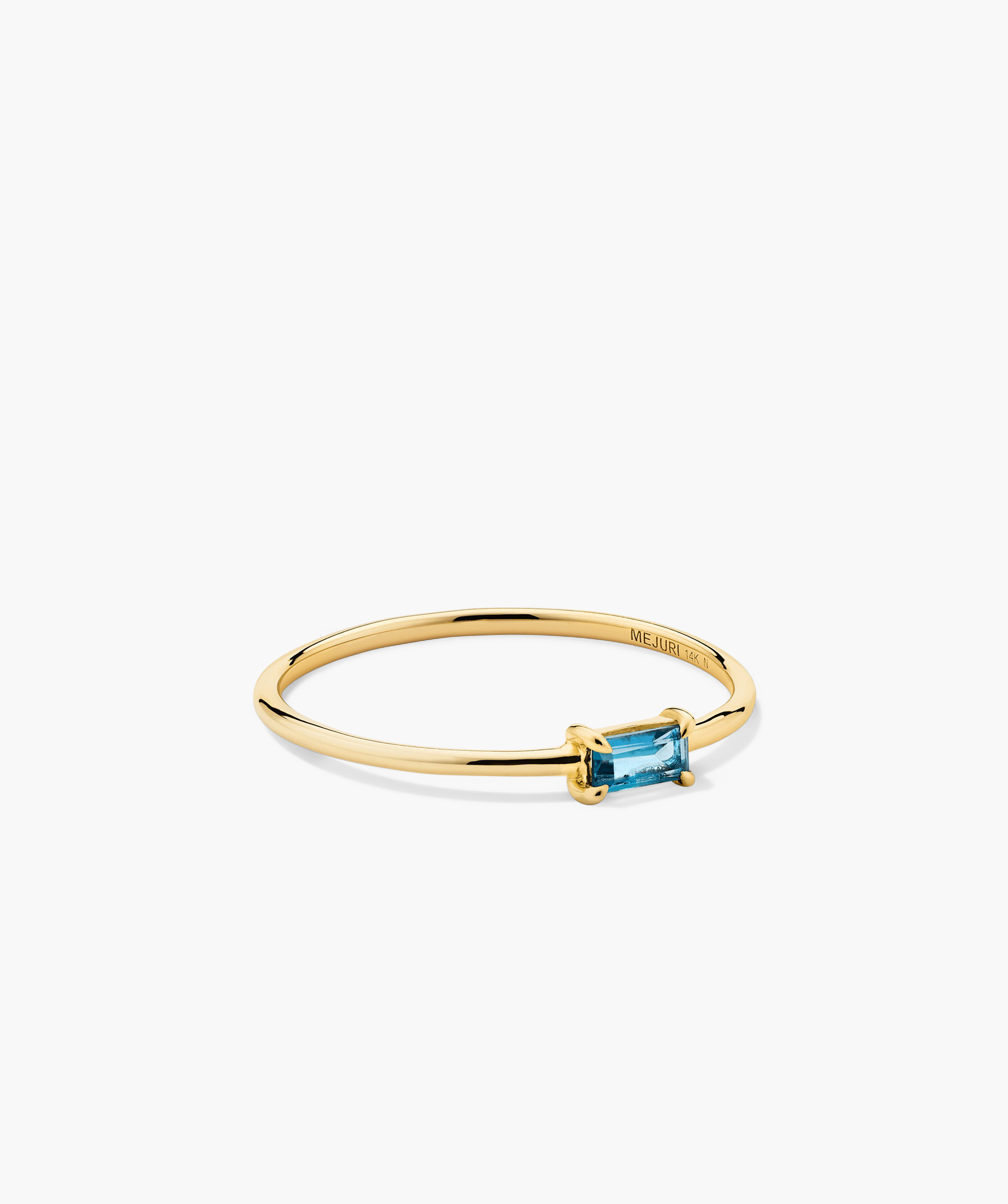 Baguette Stacker Ring featuring a gold band with a prominent blue gemstone. Ideal as a fashionable jewellery accessory or body jewelry piece.