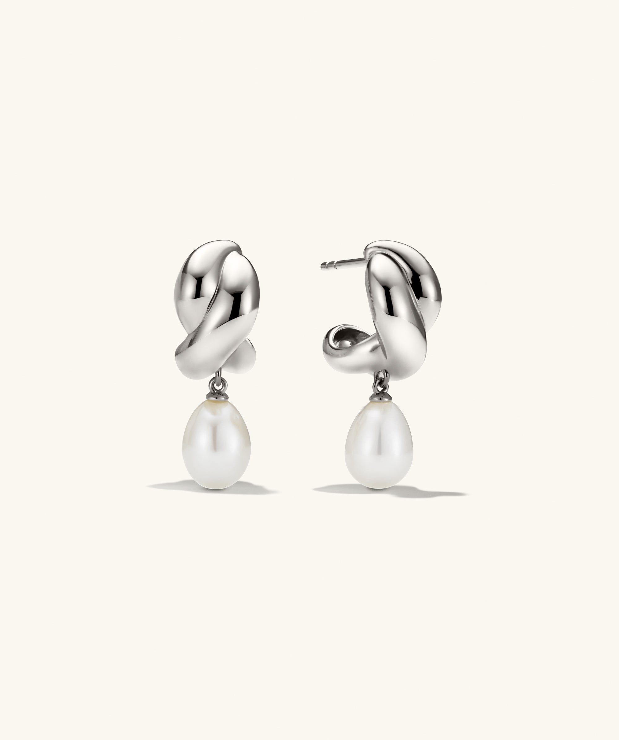 Brioche Pearl Drop Earring featuring a knot design with a moving pearl charm, combining elegance with wearability.