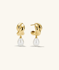 Brioche Pearl Drop Earring featuring gold hoops with a pearl charm, showcasing a knot design that offers movement and elegance.
