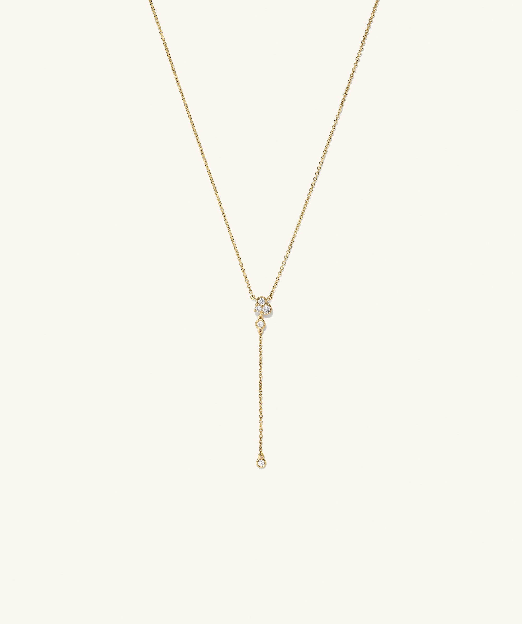 Celeste Lab Grown Diamond Lariat Necklace featuring a gold chain with a cluster of diamonds and a drop chain diamond pendant.