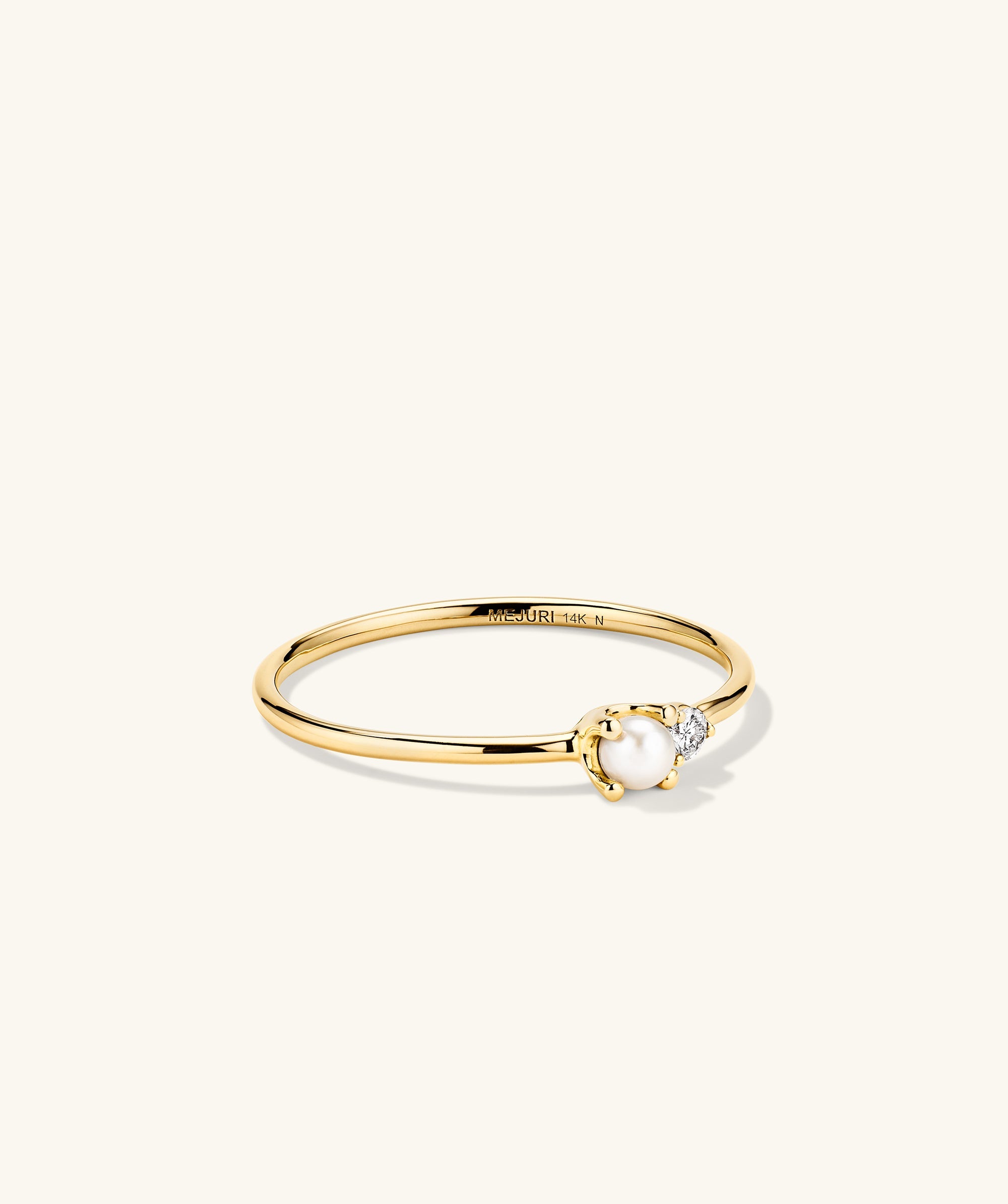 Pearl and Diamond Stacker Ring: A 14k gold ring featuring a central freshwater pearl flanked by diamonds, handcrafted for elegance and versatility.