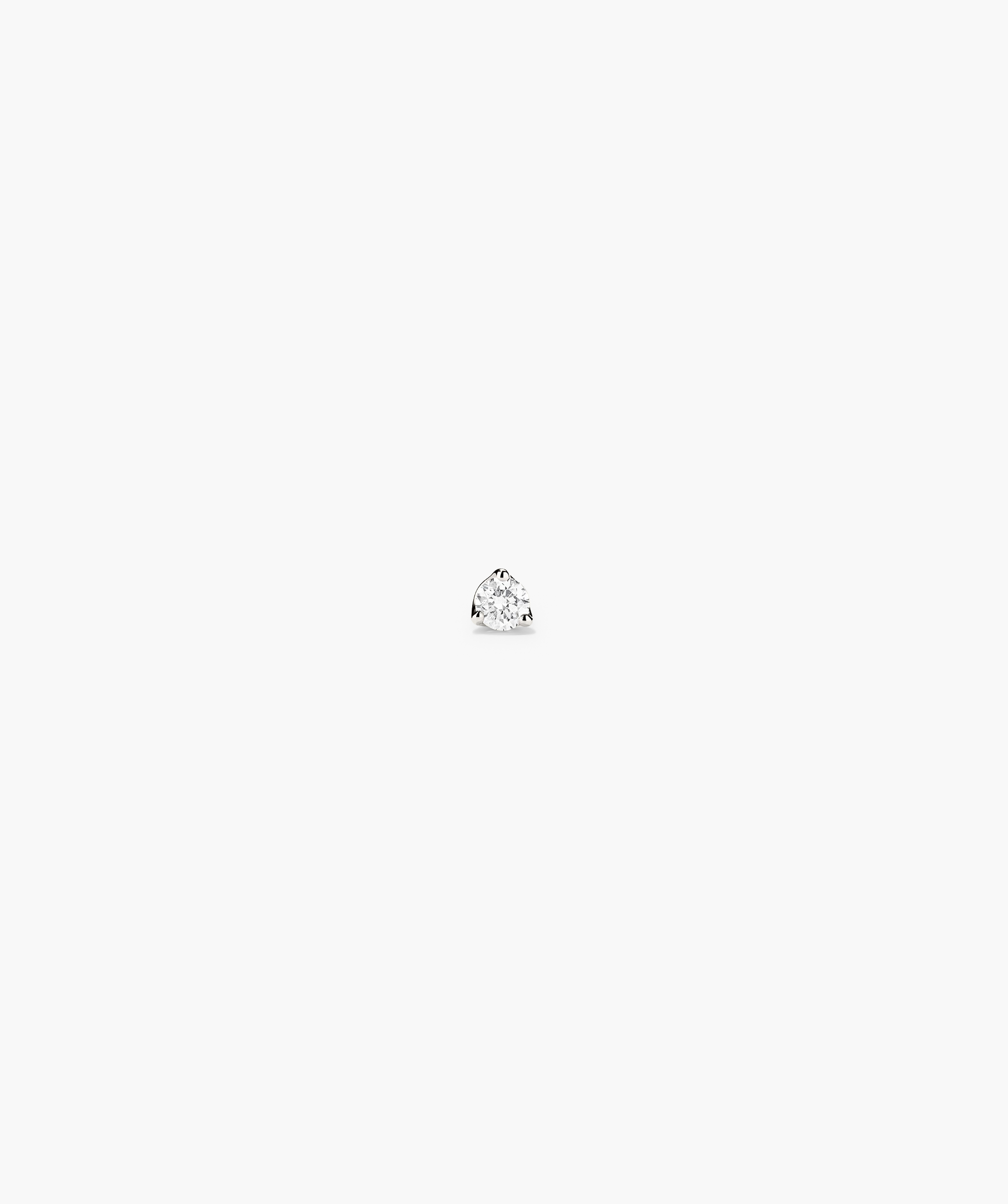 Piercing Studio - Diamond Mini Flat Back Stud on white surface, showcasing a close-up of the diamond mounted on 14k solid gold with a titanium back.