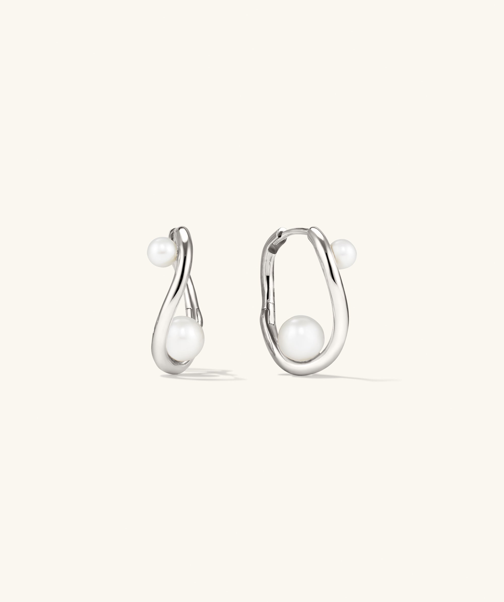 DÃ´me Figure Pearl Hoops featuring interwoven pearls of varying sizes on elegant hoops, ideal for versatile styling at any occasion.