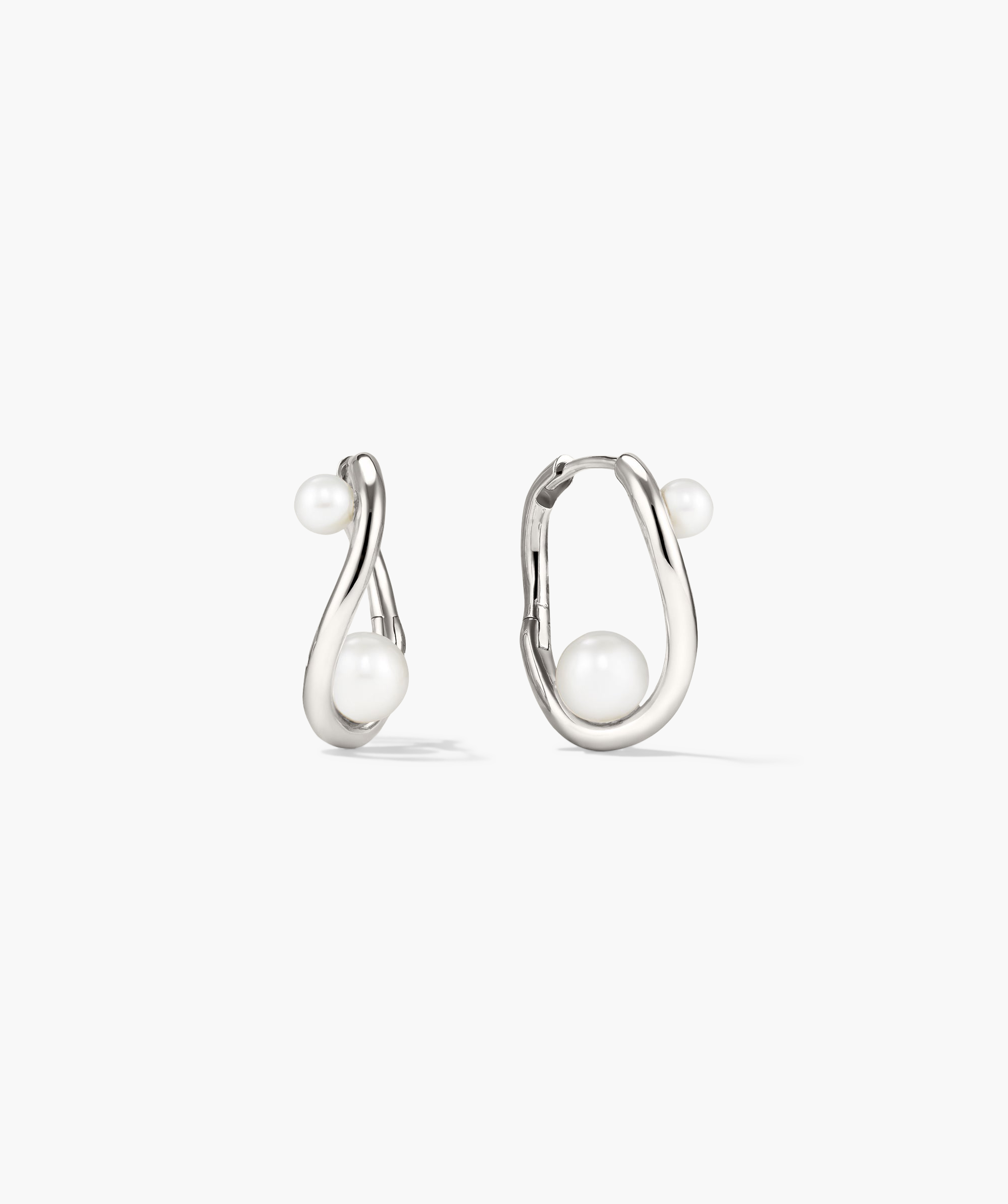 DÃ´me Figure Pearl Hoops featuring interwoven pearls of varying sizes on elegant hoops, ideal for versatile styling at any occasion.