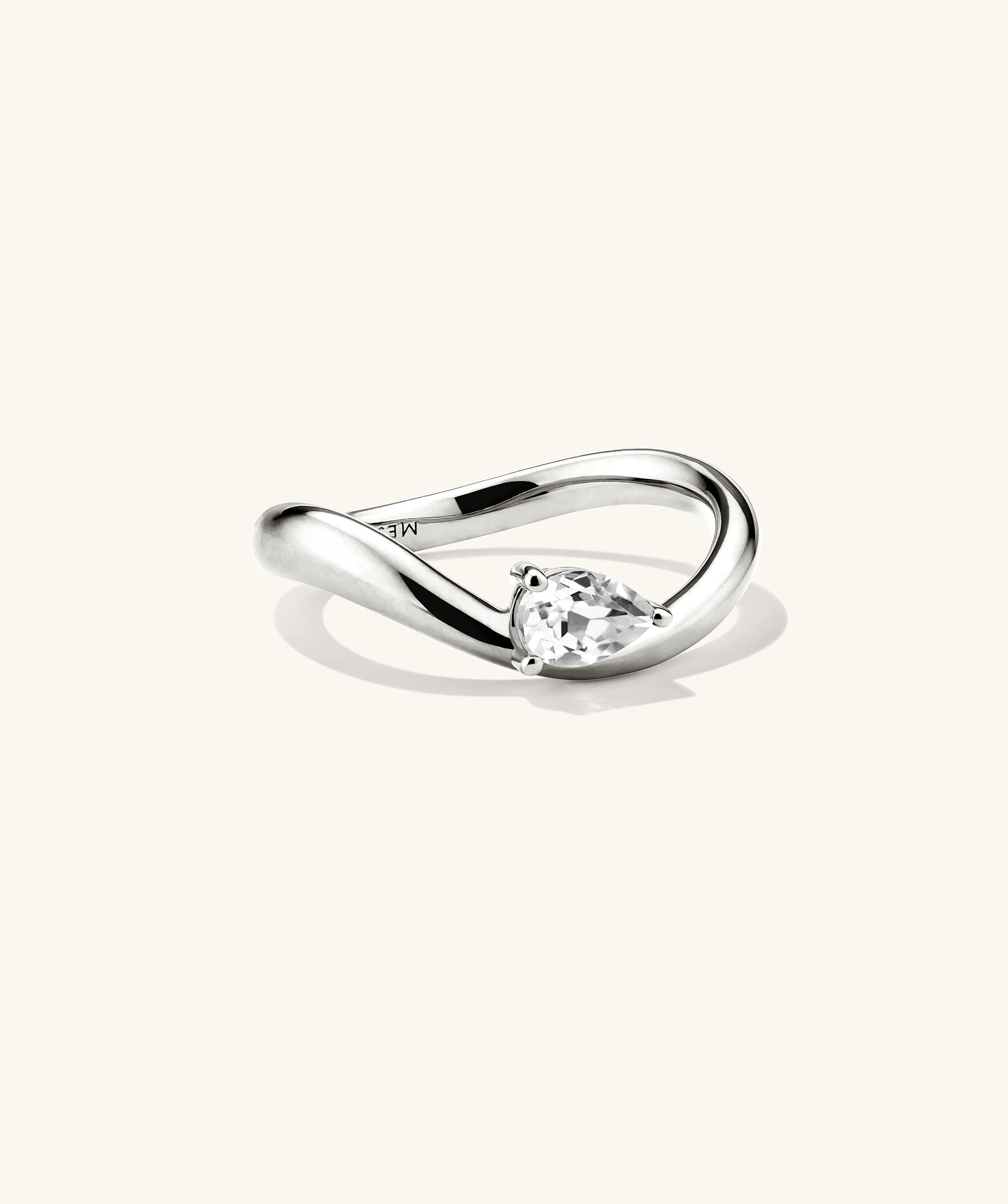 DÃ´me Figure Balance Ring with a pear cut gemstone elegantly floating above the band, ideal for layering with other DÃ´me Figure Rings.