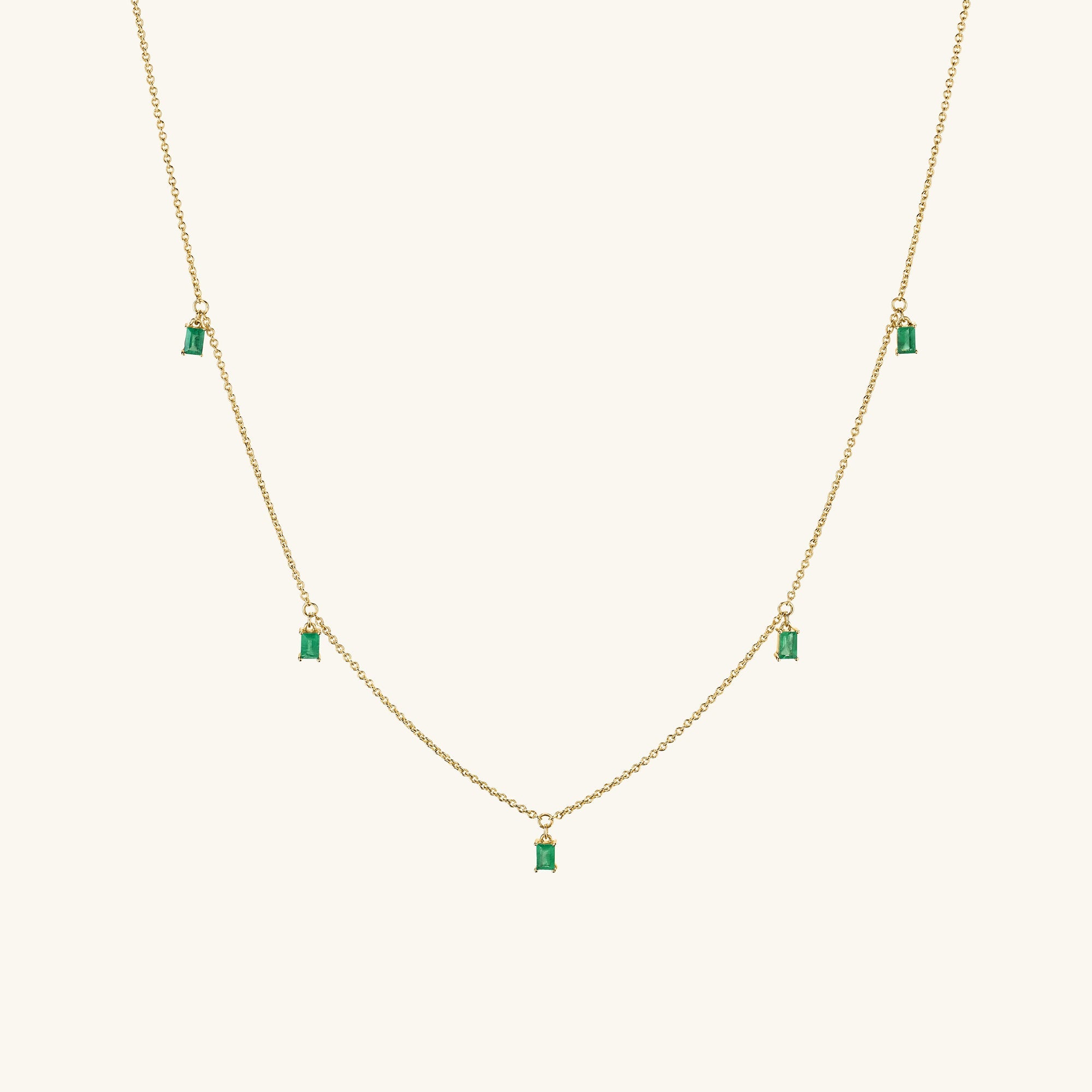 Baguette Gemstone Station Necklace featuring a gold chain adorned with green stones, ideal for layering and adding a standout shine to your collection.