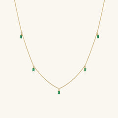Baguette Gemstone Station Necklace featuring a gold chain adorned with green stones, ideal for layering and adding a standout shine to your collection.