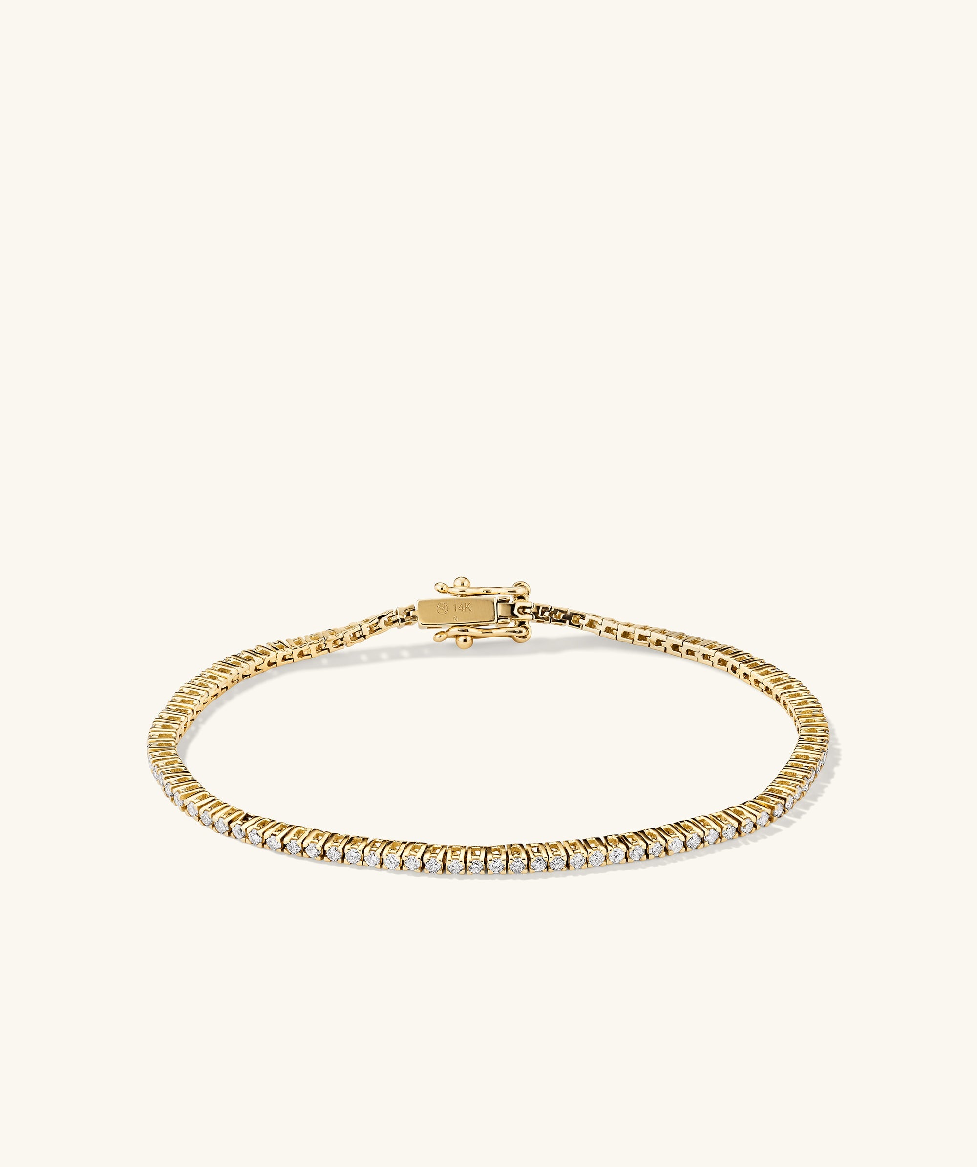 Diamond Tennis Bracelet 1.3mm, 14k gold with diamonds, featuring a secure clasp and safety arms for fastening. Handcrafted for timeless elegance.