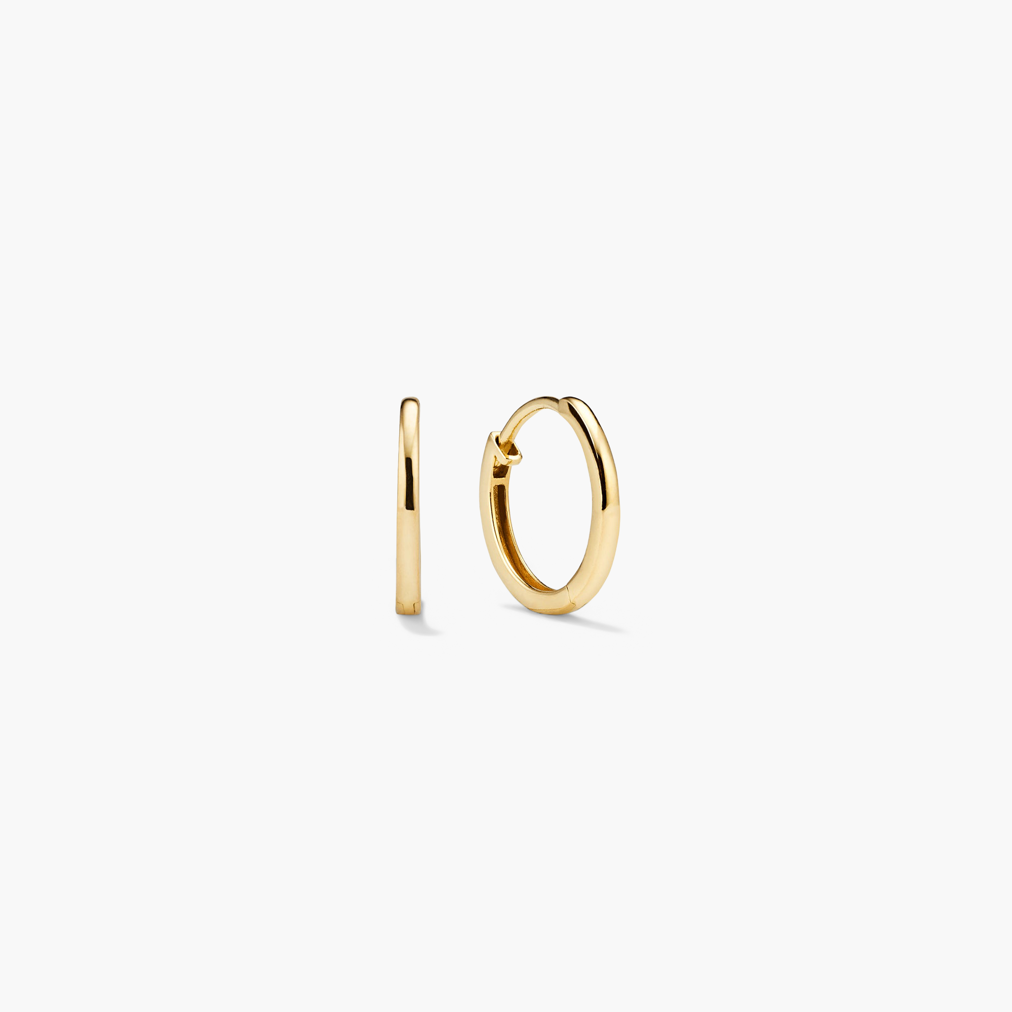 Easy Huggie Hoops: Small gold hoop earrings with a polished finish, featuring a clicker closure for comfort and security. Shown in circular and thin profile views.
