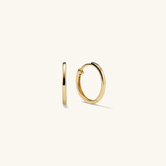 Easy Small Hoops: A pair of handcrafted 14k gold hoop earrings with a clicker closure, designed for everyday wear and maximum comfort.