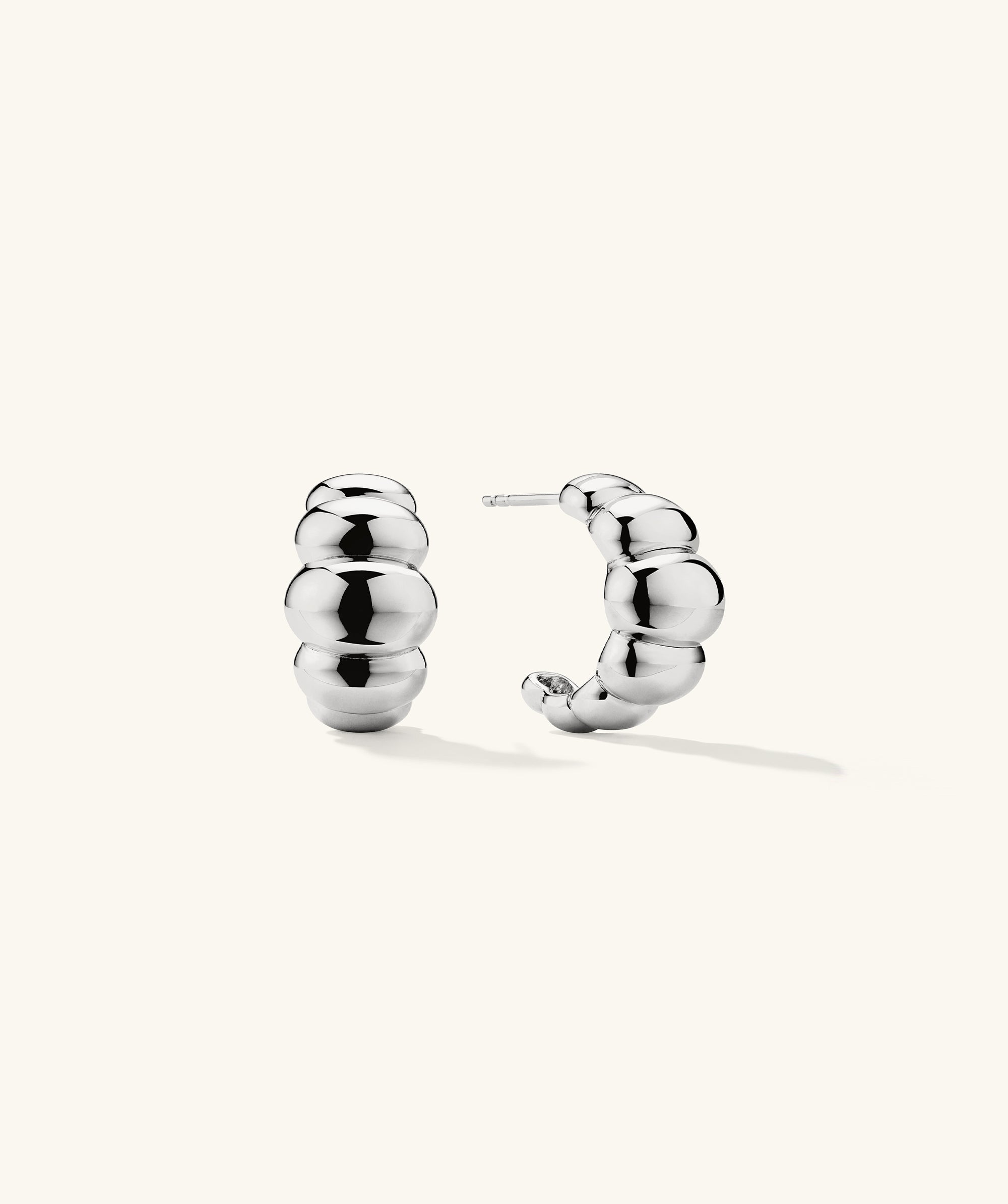 Puffy Charlotte Hoops: A pair of bold, silver earrings from the Charlotte Collection, designed for making a statement.