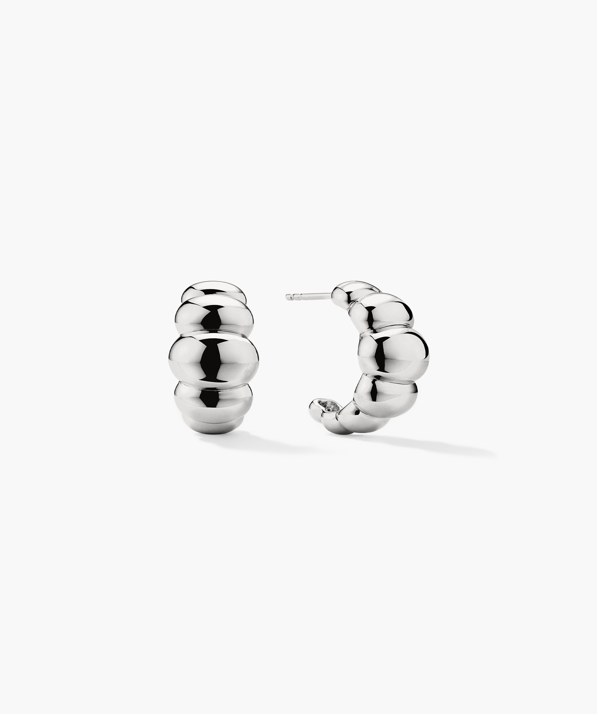 Puffy Charlotte Hoops: A pair of bold, silver earrings from the Charlotte Collection, designed for making a statement.