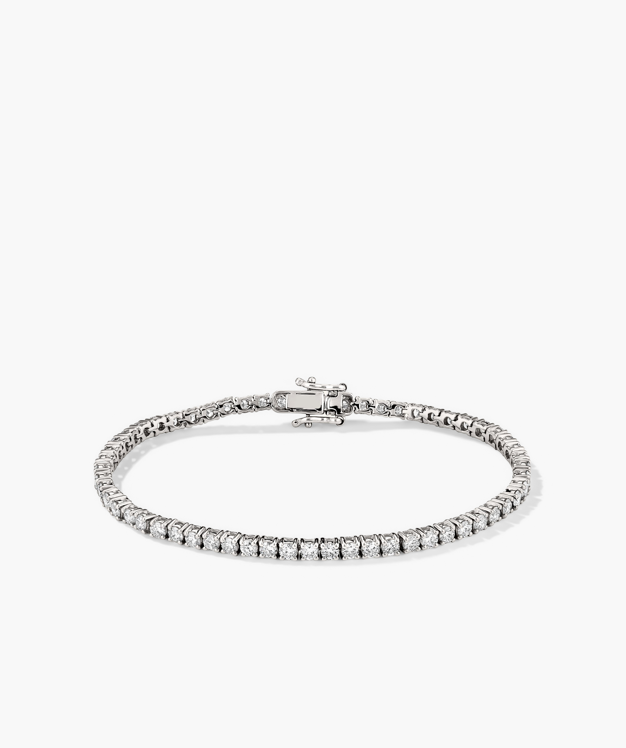 Lab Grown Diamond Tennis Bracelet 2.5mm: A close-up of a silver bracelet adorned with lab grown diamonds, showcasing its intricate clasp and secure safety arms.