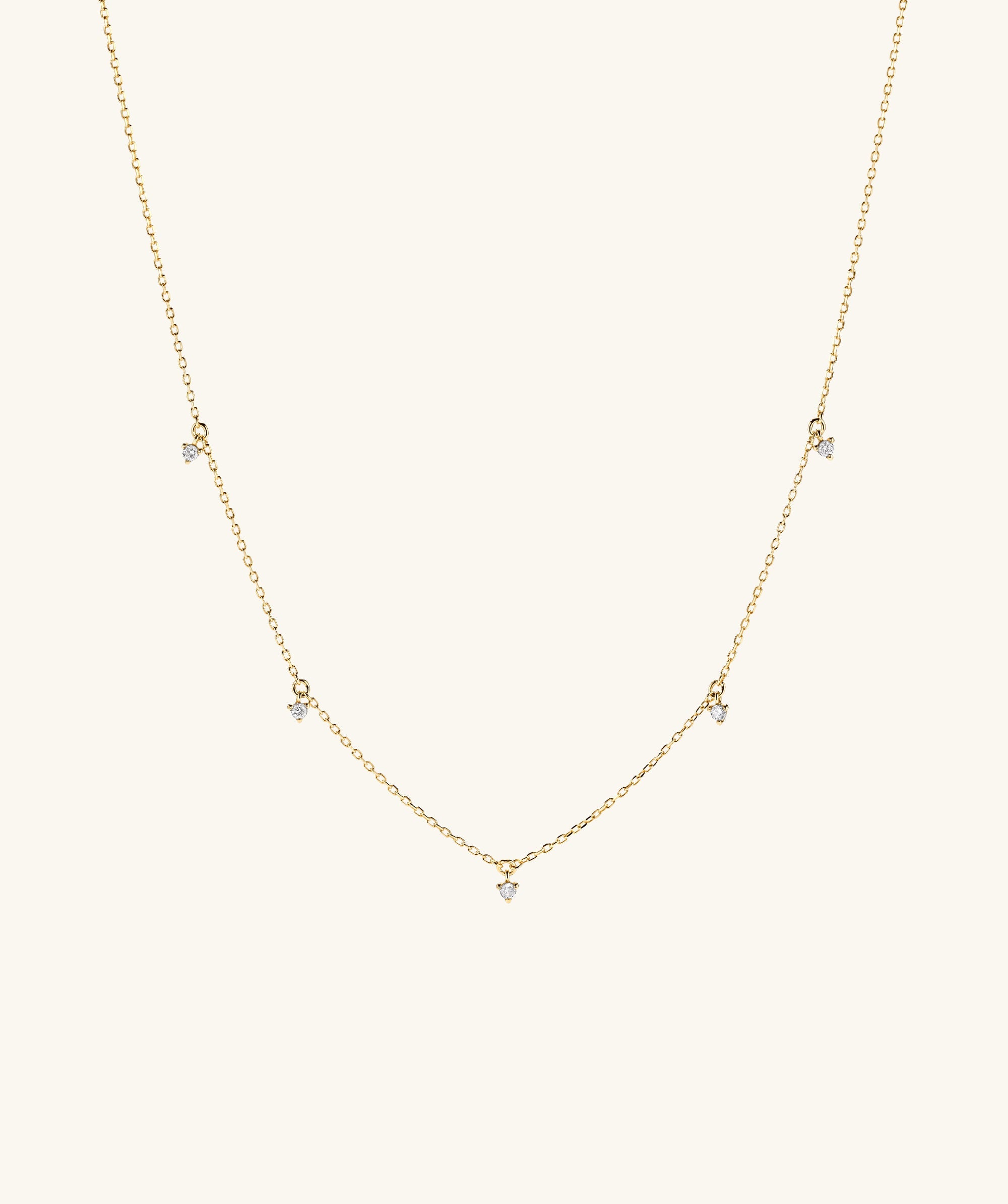 Multi Station Diamond Necklace: A 14k gold choker featuring five diamonds, blending dainty and edgy elements for a striking look.