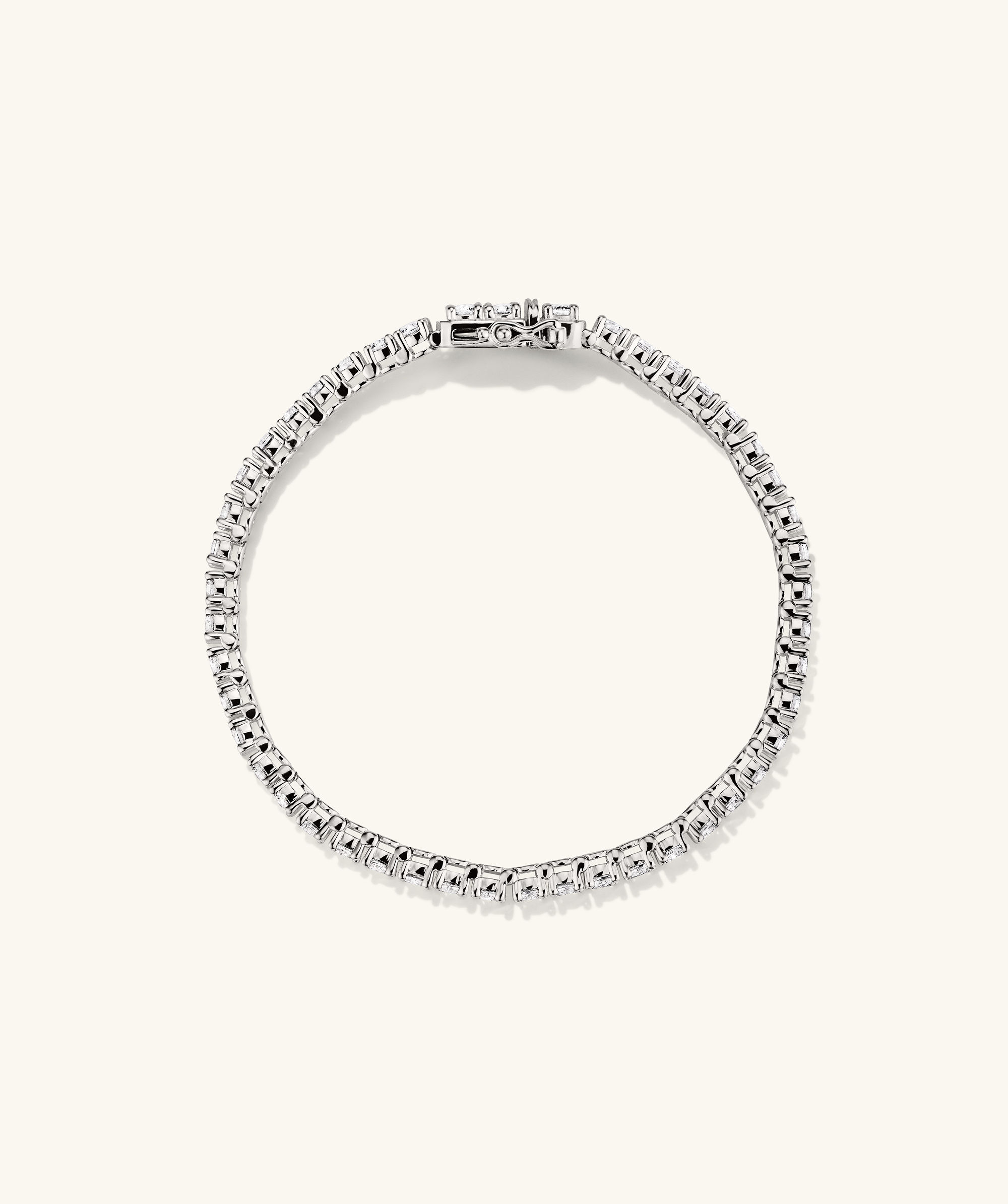 Lab Grown Sapphire Tennis Bracelet: A close-up of a silver bracelet adorned with lab grown sapphires, showcasing its elegant design and sparkling gemstones.