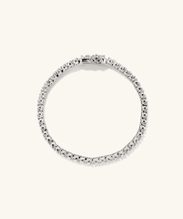 Lab Grown Sapphire Tennis Bracelet: A close-up of a silver bracelet adorned with lab grown sapphires, showcasing its elegant design and sparkling gemstones.