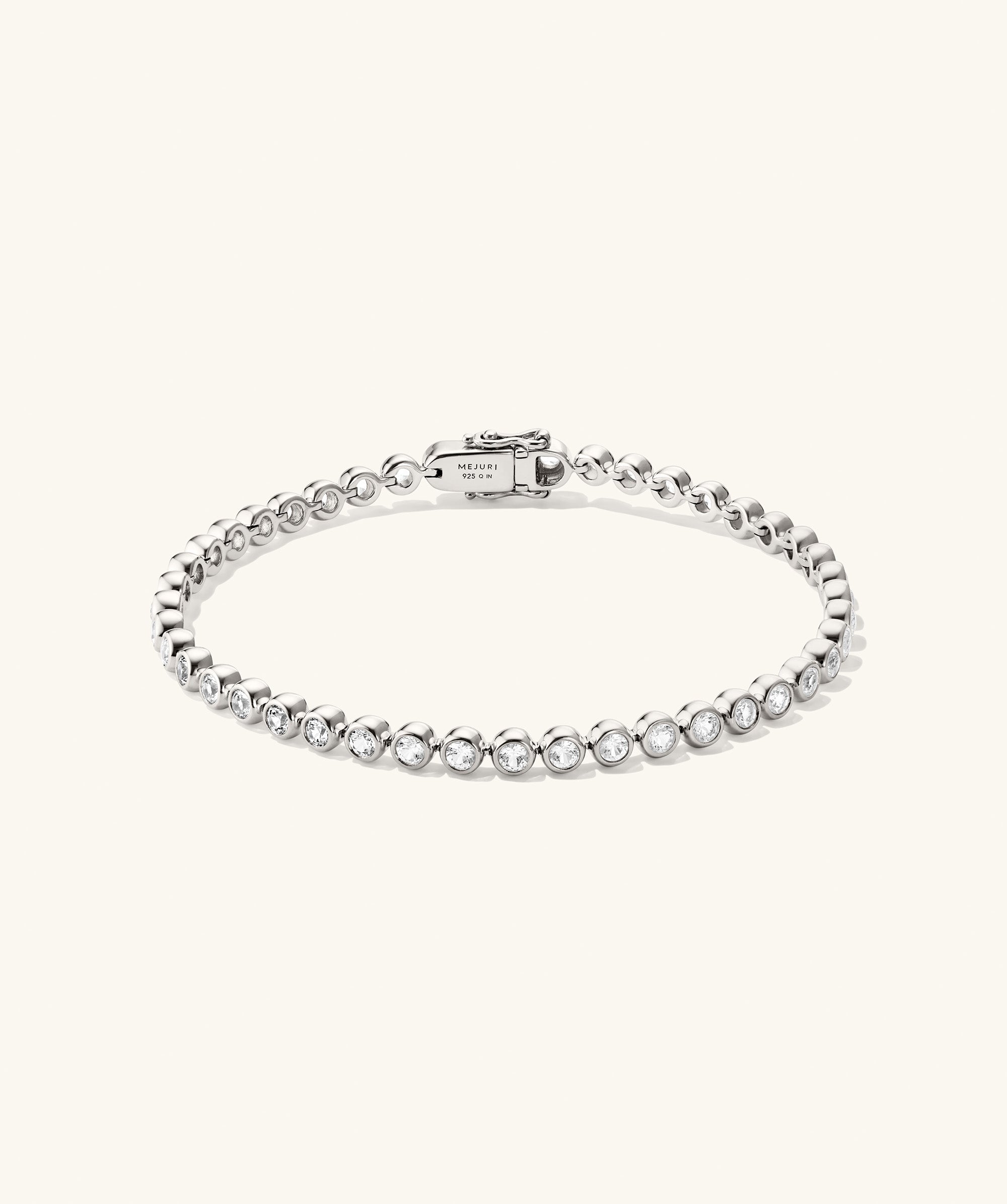 Zadie Bezel Lab Grown Sapphire Tennis Bracelet featuring a silver band with sparkling diamonds, elegantly set in a bezel design for a luxurious look.