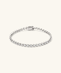 Zadie Bezel Lab Grown Sapphire Tennis Bracelet featuring a silver band with sparkling diamonds, elegantly set in a bezel design for a luxurious look.