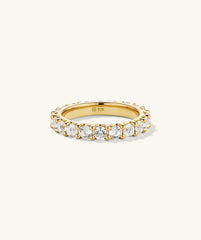 Aurora Lab Grown Sapphire Eternity Ring featuring lab grown sapphires encircling a gold band, embellished with diamonds, showcasing a luxurious, continuous design.
