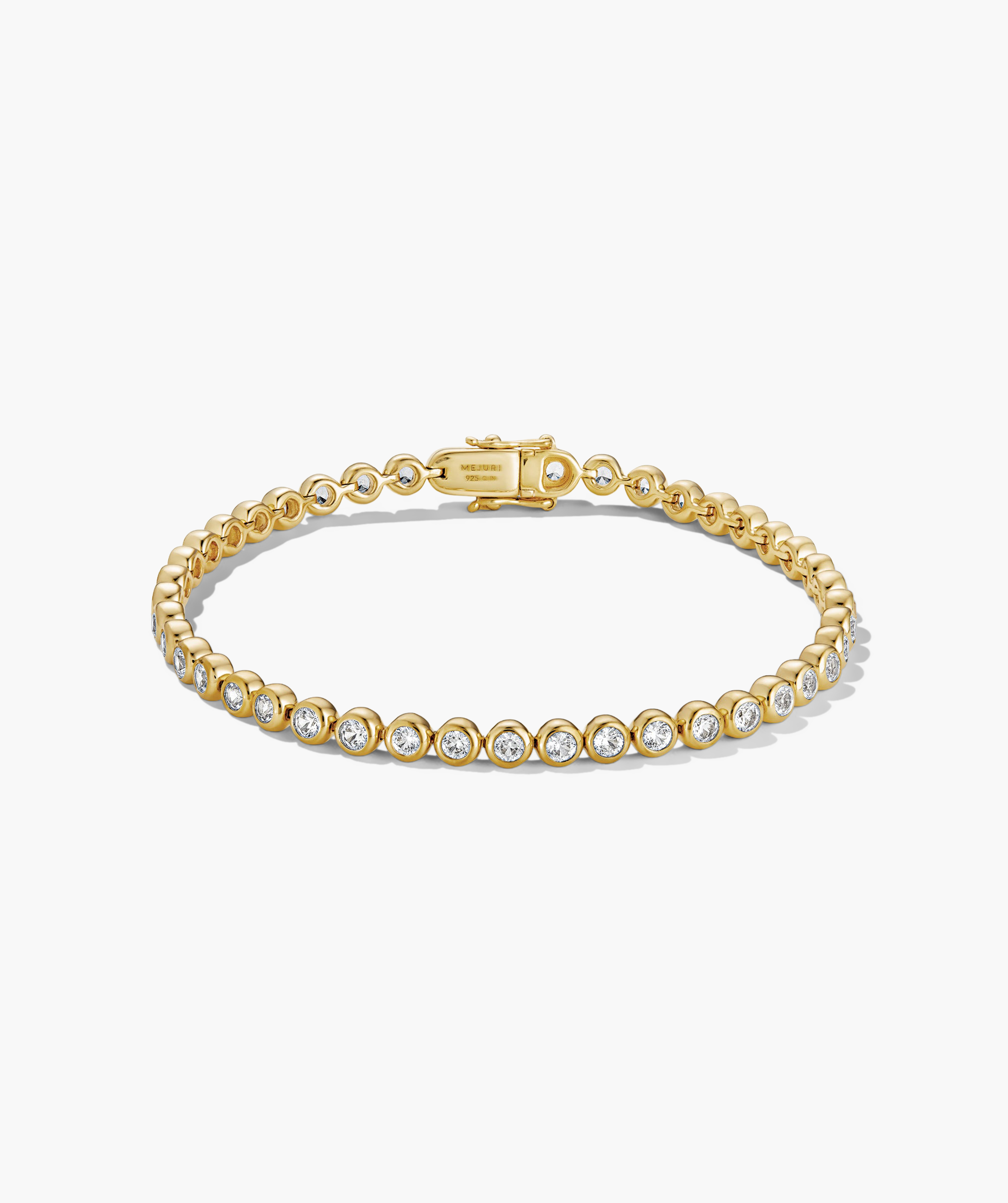Zadie Bezel Lab Grown Sapphire Tennis Bracelet featuring gold design with diamond accents, showcasing its elegant bezel setting and sophisticated appeal.