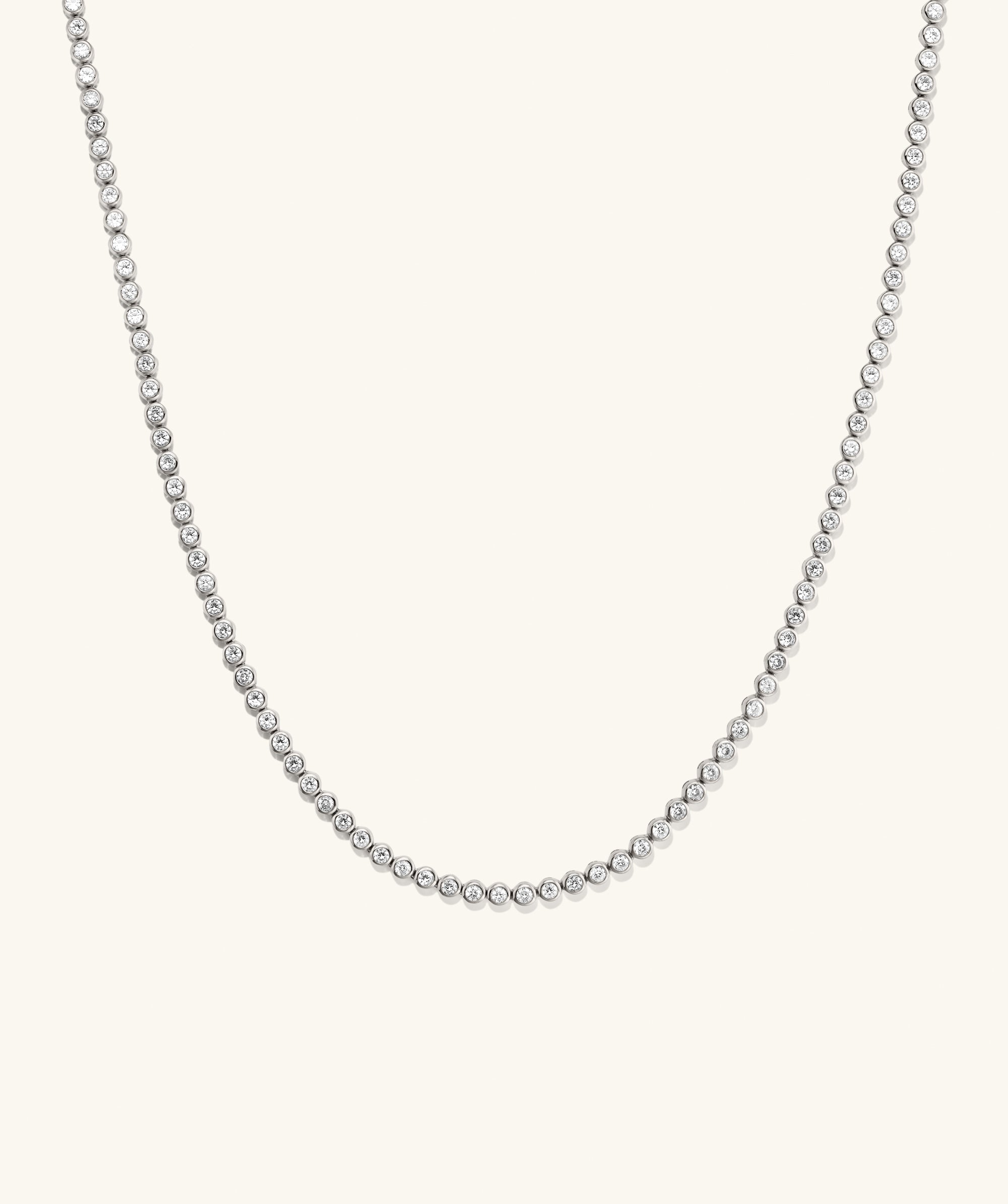 Zadie Bezel Lab Grown Sapphire Tennis Necklace featuring a silver chain adorned with sparkling diamonds, showcasing a sleek bezel setting for enhanced brilliance.