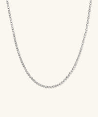 Zadie Bezel Lab Grown Sapphire Tennis Necklace featuring a silver chain adorned with sparkling diamonds, showcasing a sleek bezel setting for enhanced brilliance.