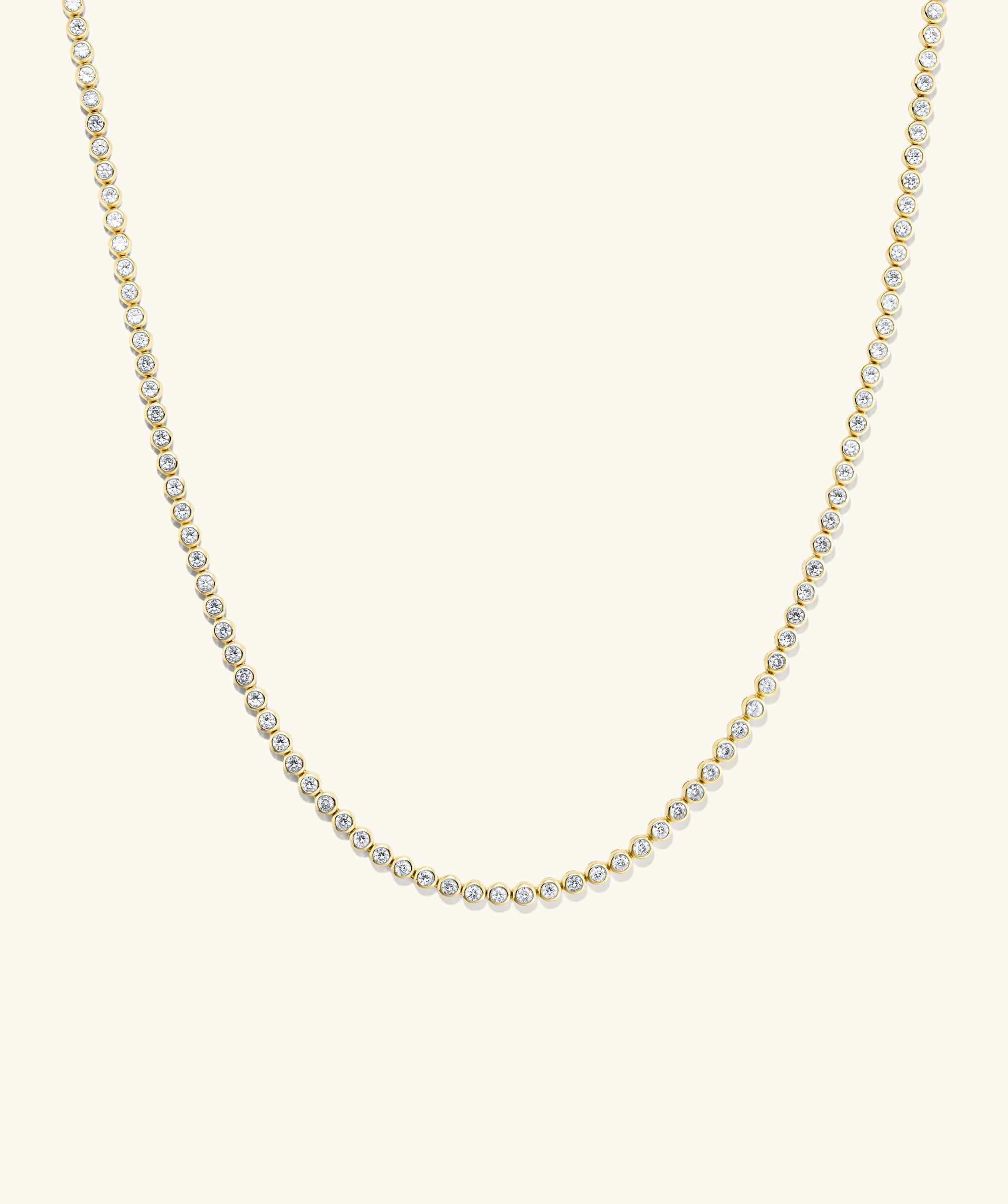 Zadie Bezel Lab Grown Sapphire Tennis Necklace featuring a gold chain with diamonds, showcasing a luxurious bezel setting for ultimate shine.