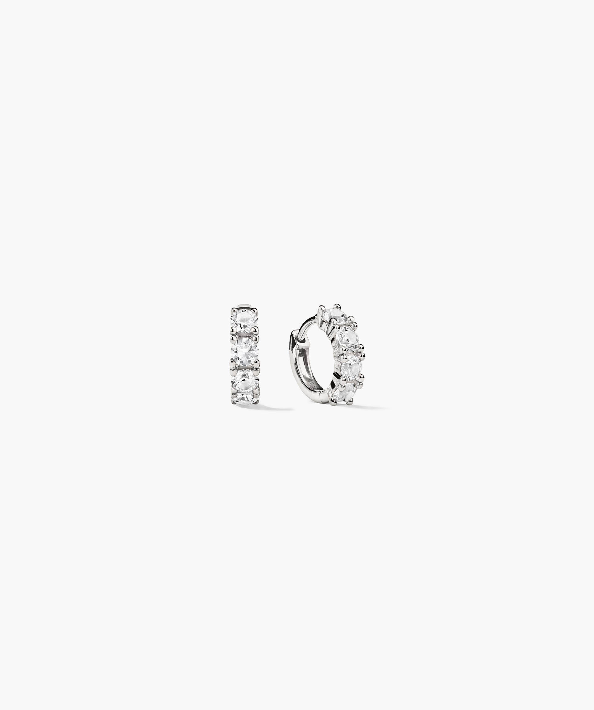 Lab Grown Sapphire Huggie: a pair of 12mm hoop earrings featuring lab-grown round white sapphires, designed for everyday wear with a dainty, impactful shine.