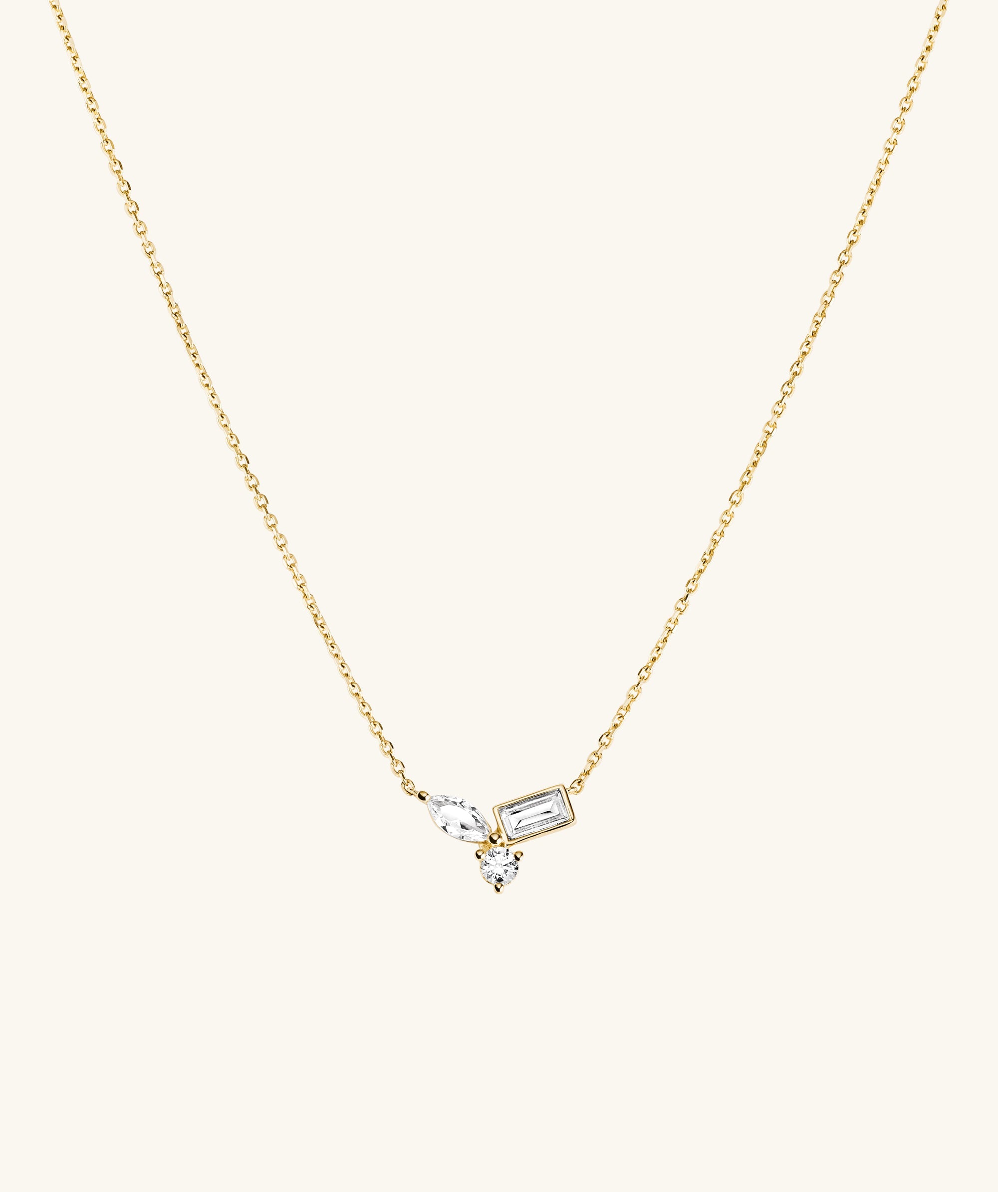 Lab Grown Sapphire Cluster Necklace featuring gold chain adorned with diamonds and a cross pendant, showcasing marquise, emerald, and round cut lab grown sapphires.