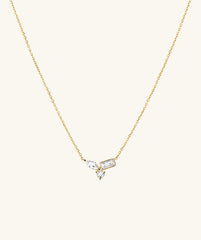 Lab Grown Sapphire Cluster Necklace featuring gold chain adorned with diamonds and a cross pendant, showcasing marquise, emerald, and round cut lab grown sapphires.