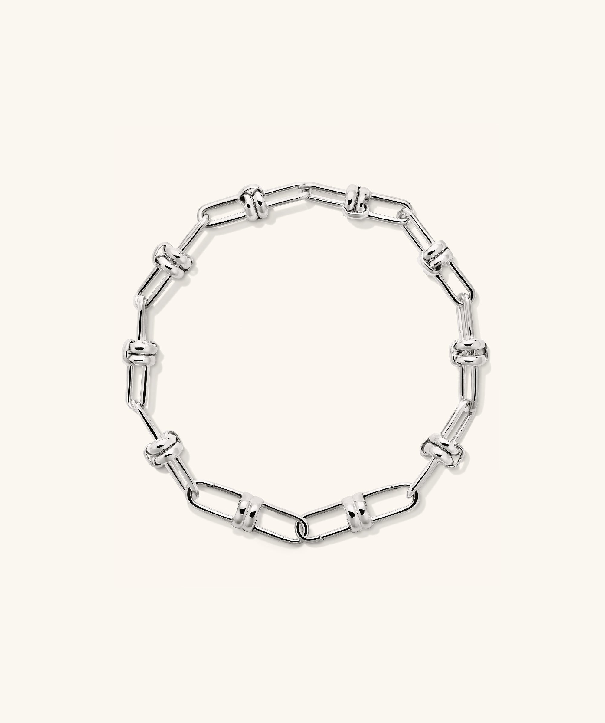 Mejuri Custom Chain Bracelet: A silver chain with interlocking links, designed for customization with charms, offering a unique and personal accessory experience.