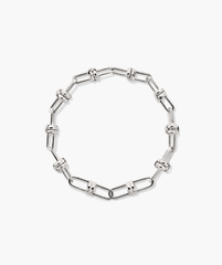 Mejuri Custom Chain Bracelet: A silver chain with interlocking links, designed for customization with charms, offering a unique and personal accessory experience.