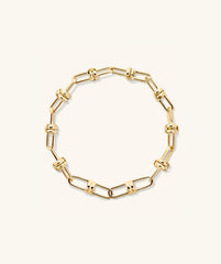 Mejuri Custom Chain Bracelet: a gold chain with interlocking links designed for customization, allowing for charm additions and personalized styling.