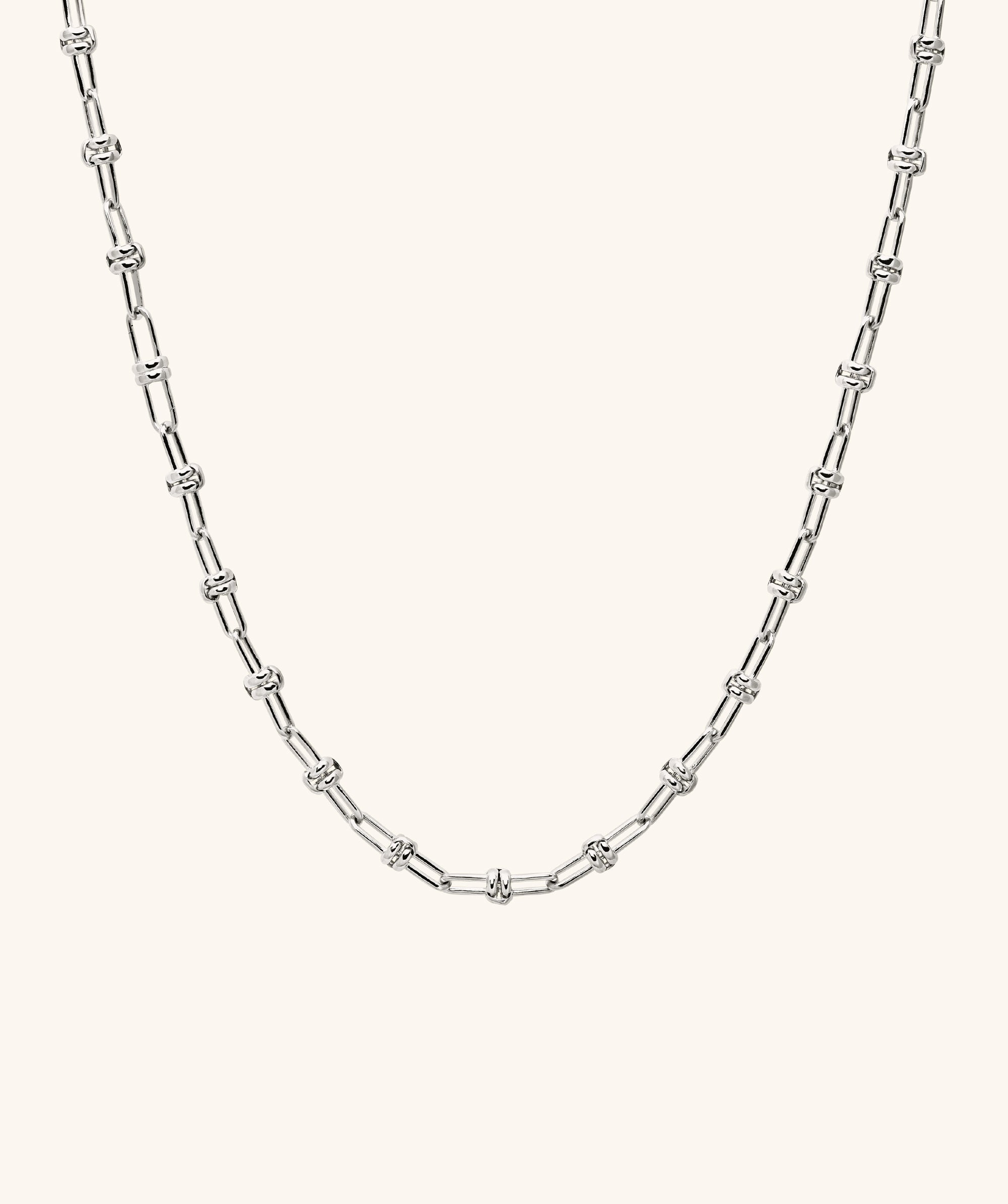 Multi Way Chain Necklace: Close-up of a silver chain with a knot, showcasing versatile links for customizable styles, designed for unique personalization.