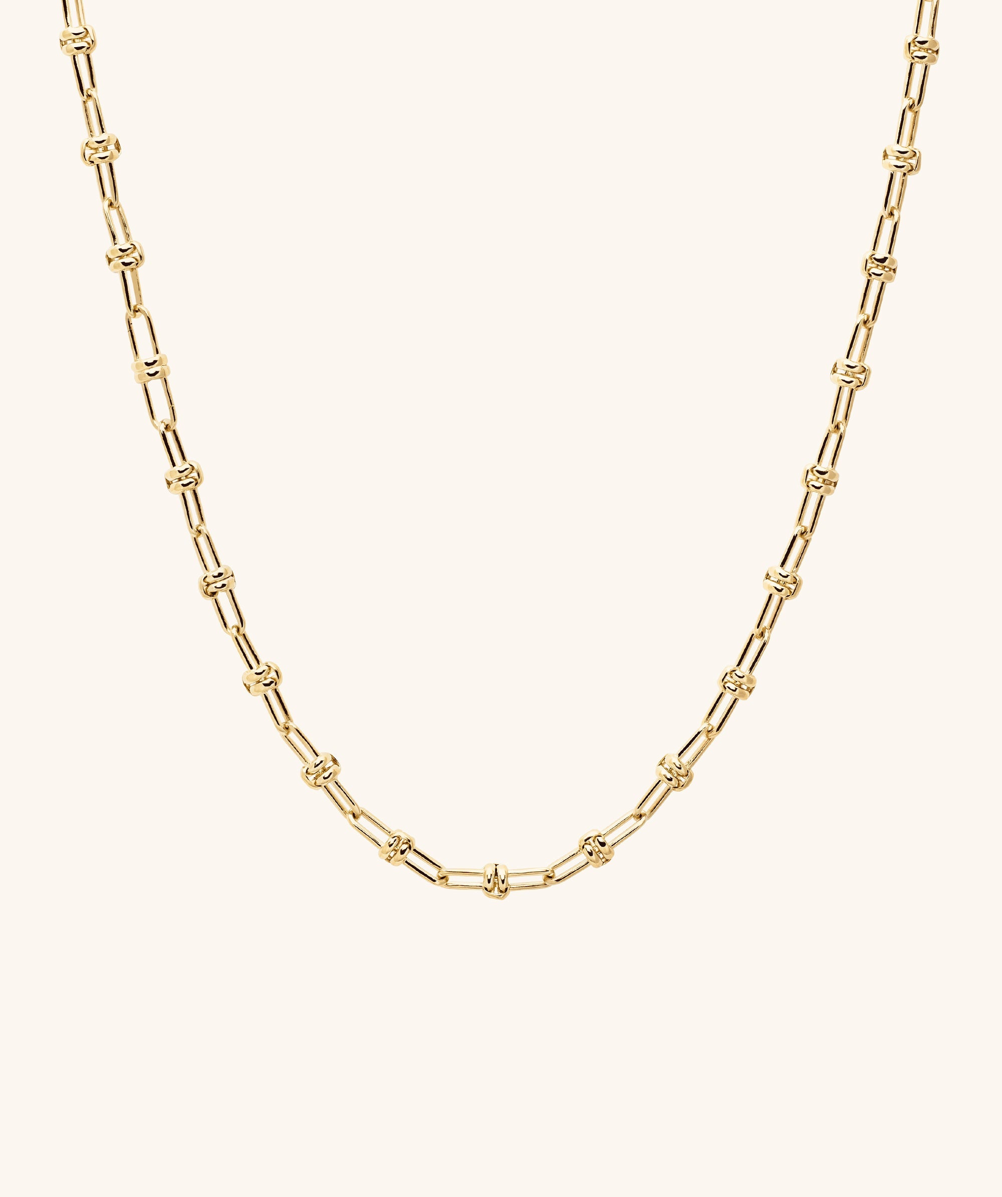 Multi Way Chain Necklace featuring a gold chain with a distinctive knot, designed for customizable styling and versatile wear.