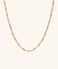 Multi Way Chain Necklace featuring a gold chain with a distinctive knot, designed for customizable styling and versatile wear.