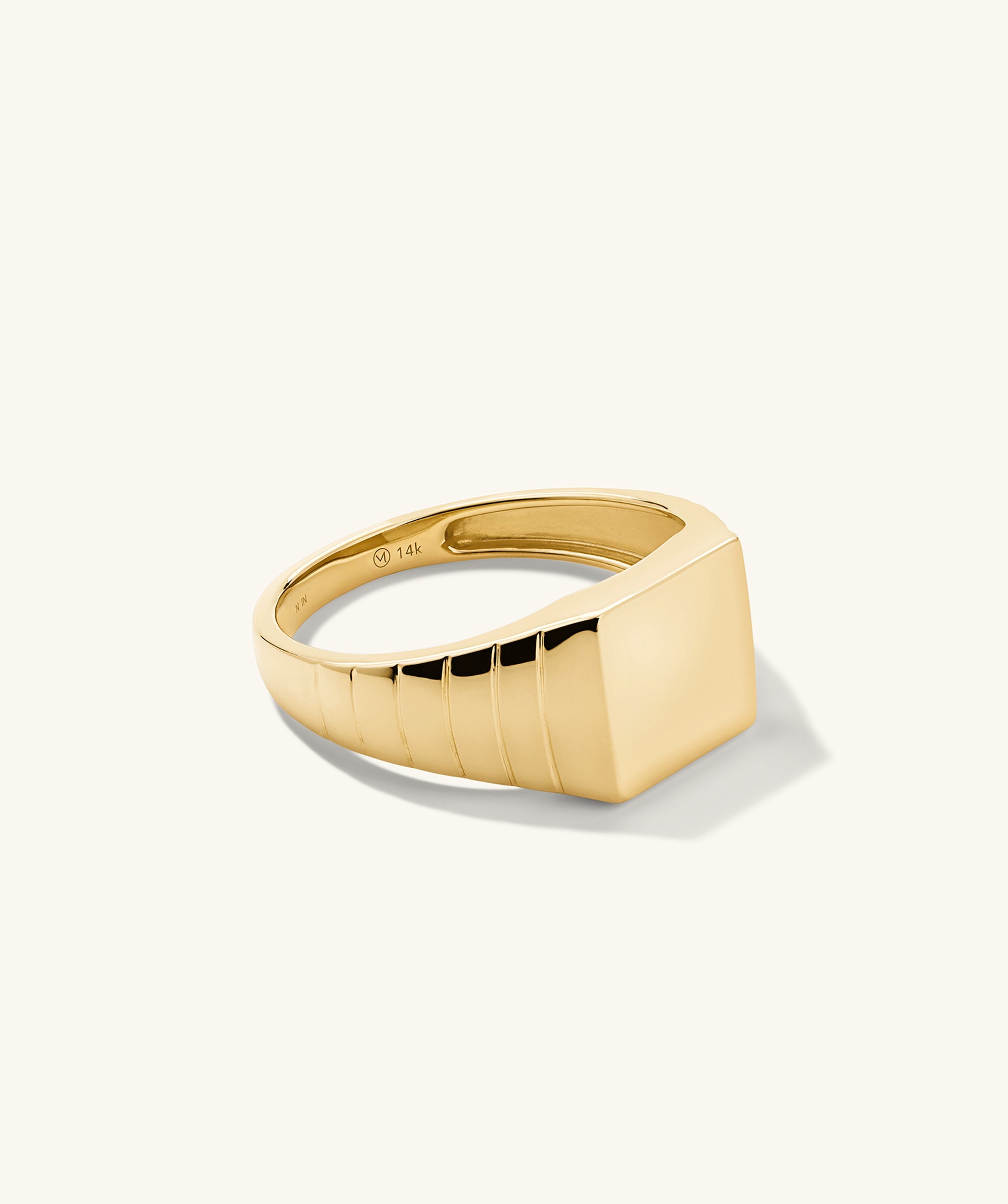 Square Signet Ring: A bold gold ring featuring a square design, ideal for making a statement in any jewelry collection.