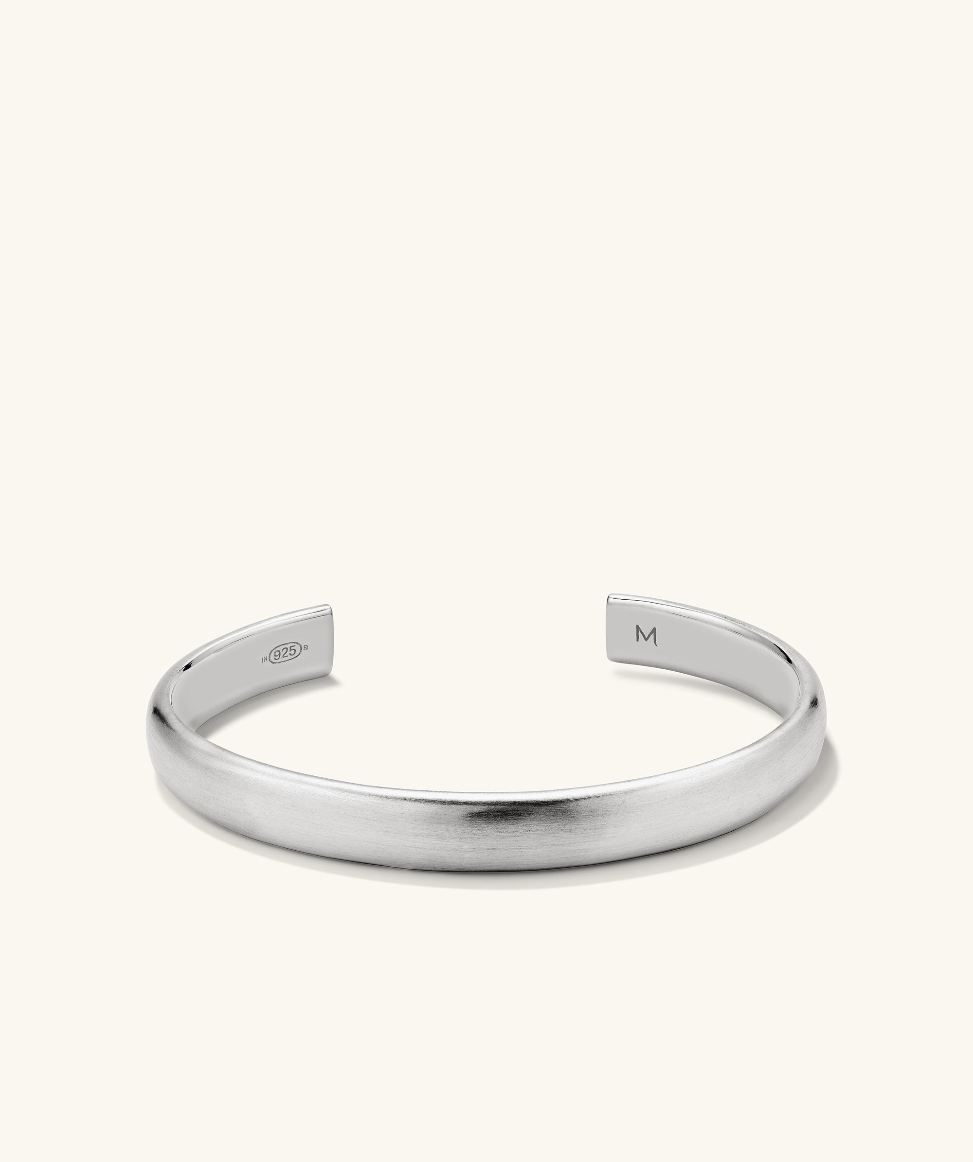 Bold Cuff: A silver bracelet featuring a sleek, square-shaped design, offering a simple yet bold silhouette that complements any outfit.