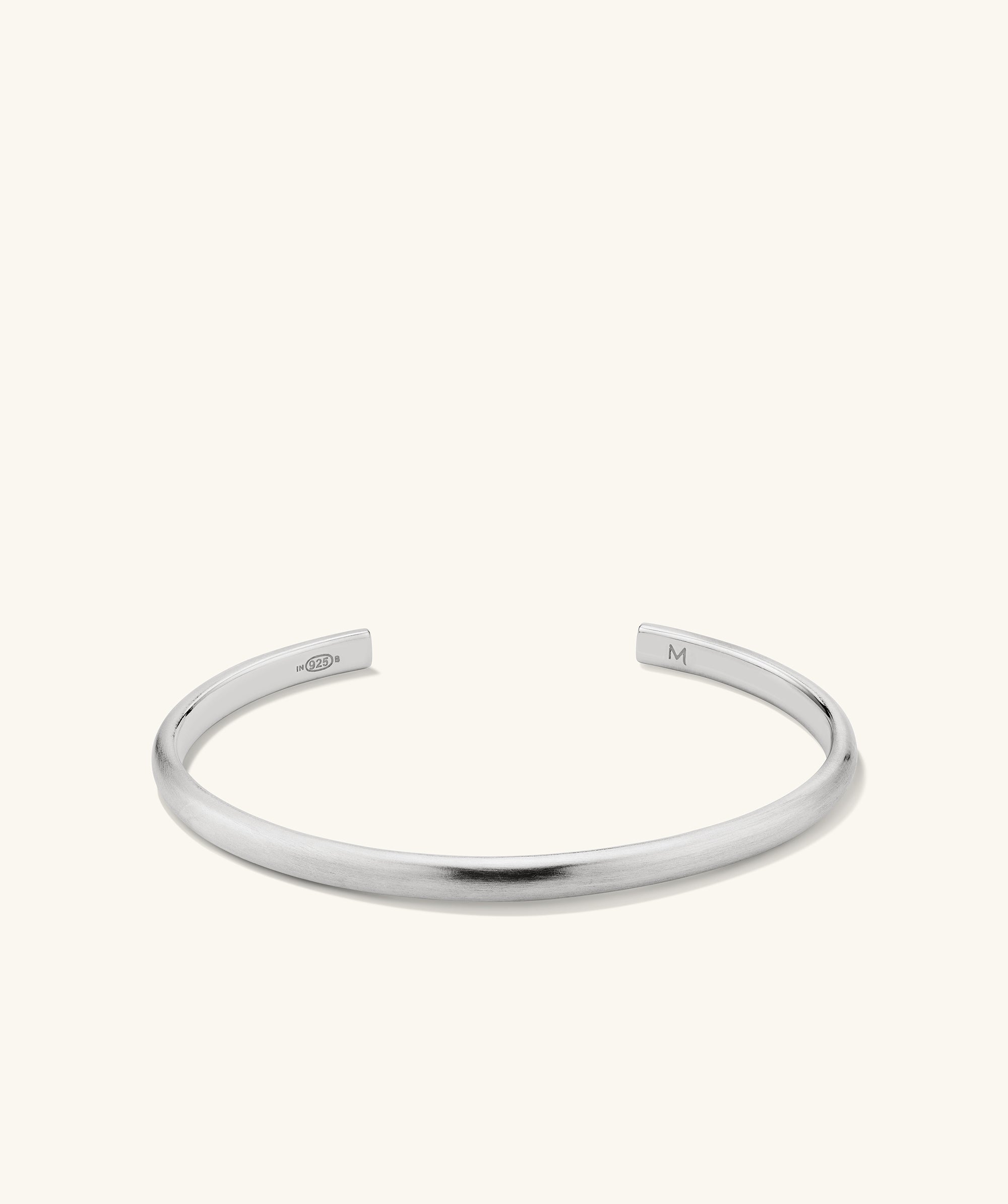 Slim Cuff: A simple, elegant silver bracelet with a smooth finish, featuring a sleek, minimalist design, perfect for versatile fashion pairing.