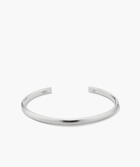 Slim Cuff: A simple, elegant silver bracelet with a smooth finish, featuring a sleek, minimalist design, perfect for versatile fashion pairing.