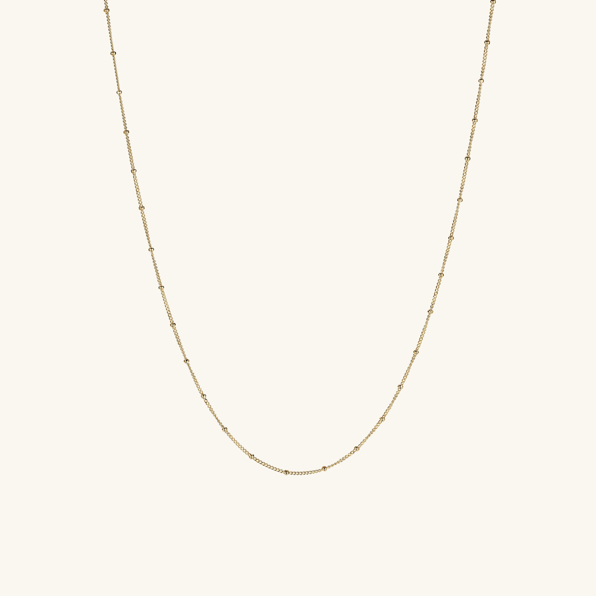 Spheres Chain Necklace: A minimalistic gold chain featuring a small diamond pendant, perfect for any occasion, making a subtle yet significant fashion statement.