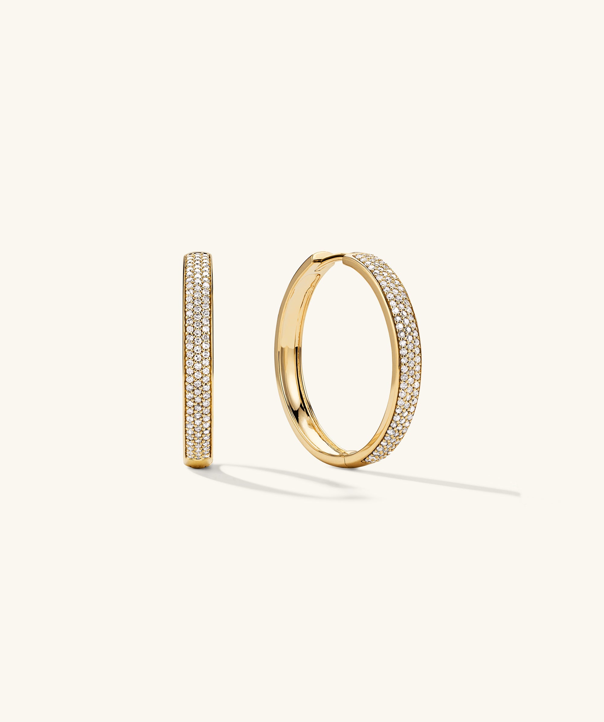 Bold PavÃ© Diamond Large Hoops: Gold hoop earrings adorned with diamonds, handcrafted in 14k solid gold, highlighting their elegant and luxurious design.