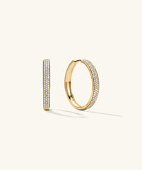 Bold PavÃ© Diamond Large Hoops: Gold hoop earrings adorned with diamonds, handcrafted in 14k solid gold, highlighting their elegant and luxurious design.