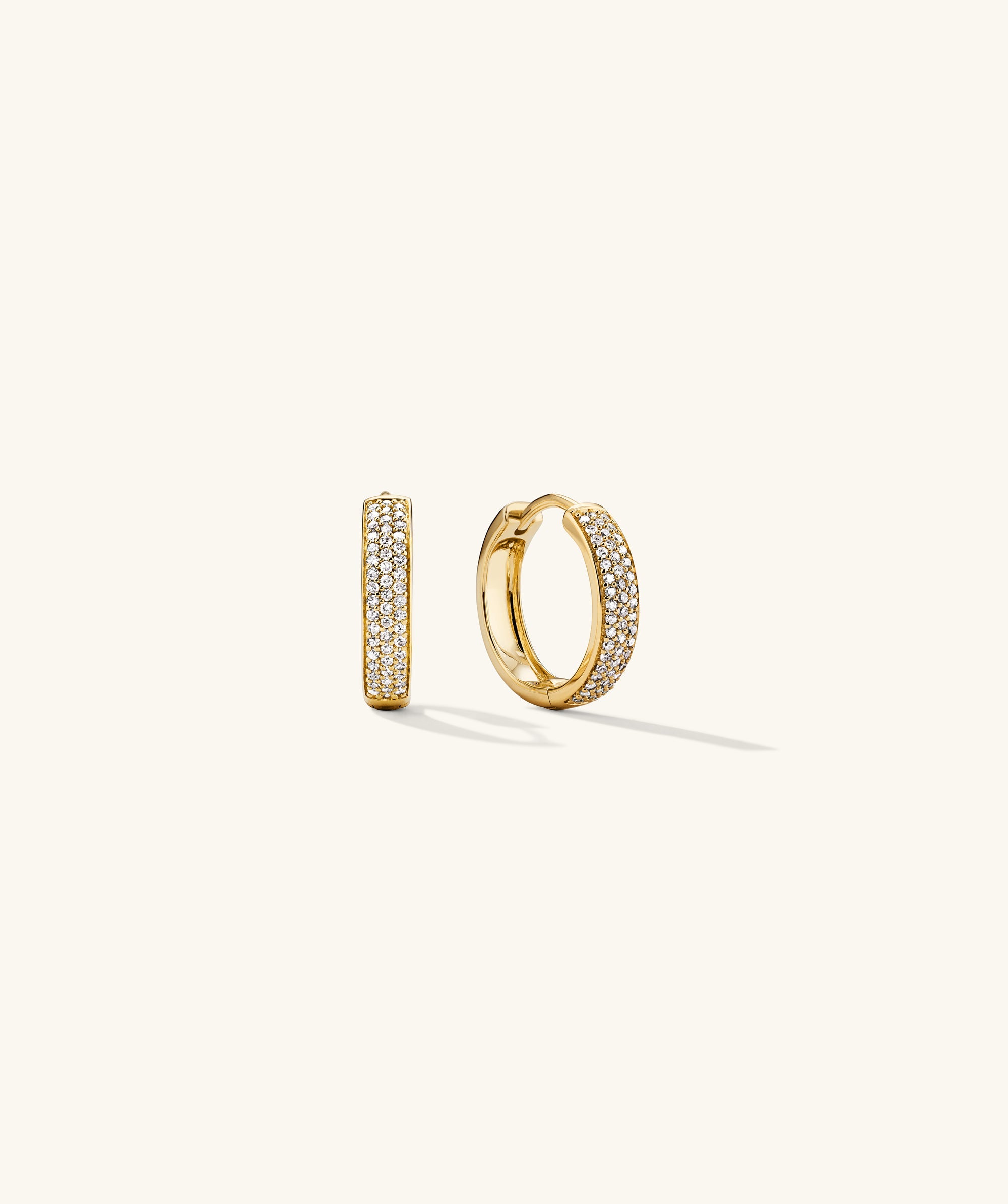 Bold PavÃ© Diamond Small Hoops: Handcrafted 14k gold earrings featuring responsibly sourced diamonds, designed to attract compliments with their elegant sparkle.