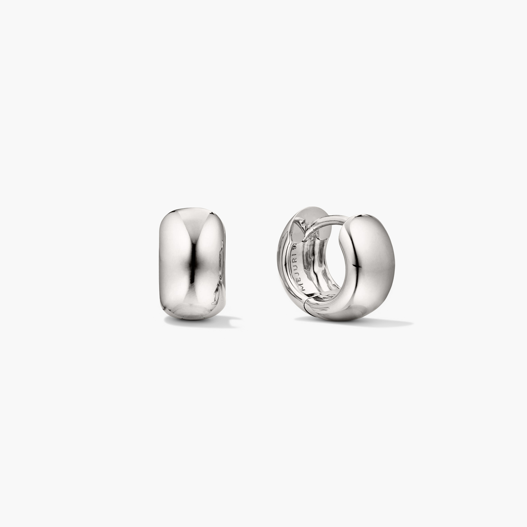 Chunky Huggie Hoops: A pair of silver hoop earrings with a clicker closure, designed for comfort and secure stacking.